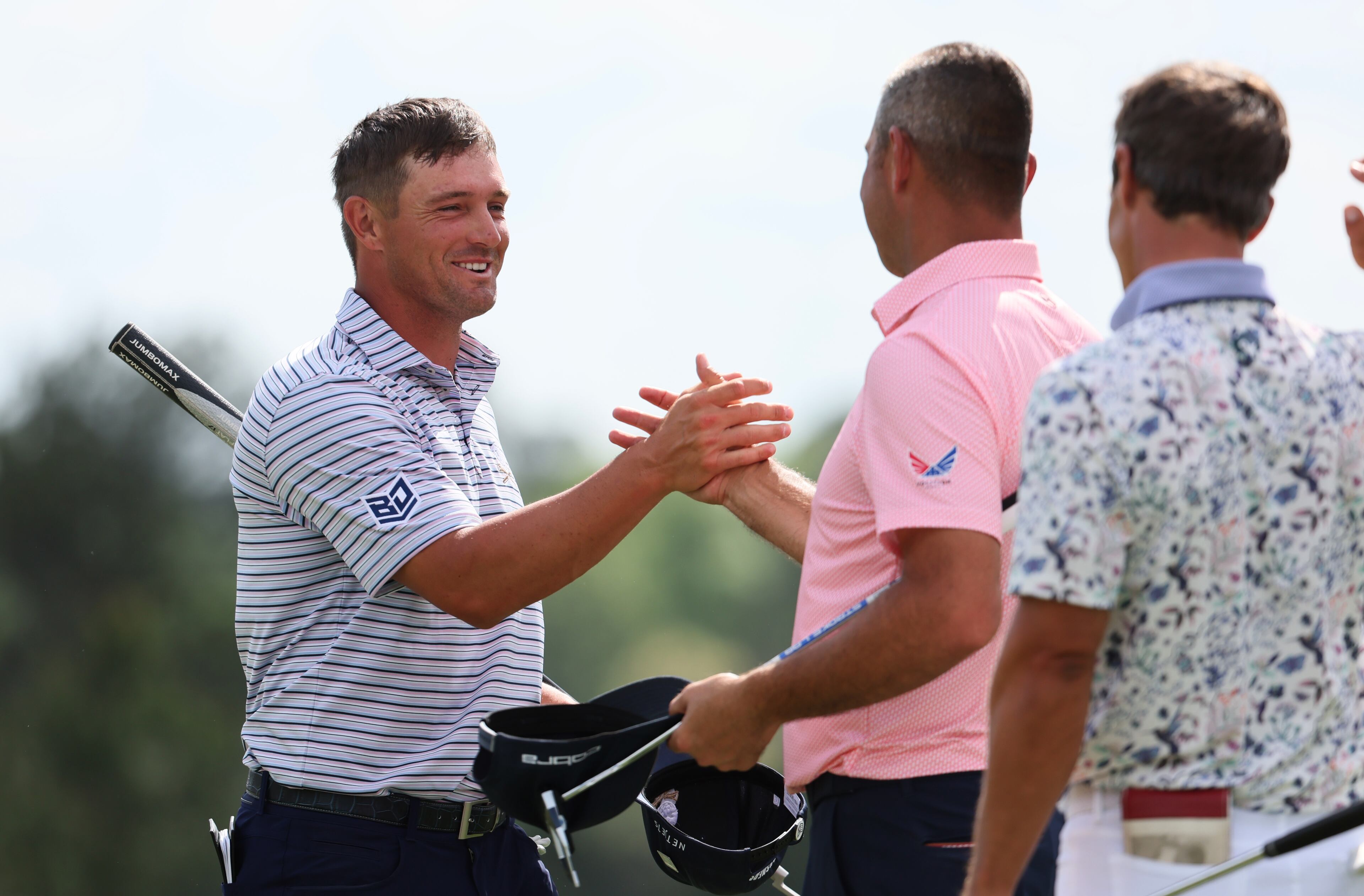 Bryson DeChambeau greets Gary Woodland as he finishes the first round at the 2024 Masters Tournament at Augusta National Golf Club, Thursday, April 11, 2024, in Augusta, Ga. Jason Getz / Jason.Getz@ajc.com)