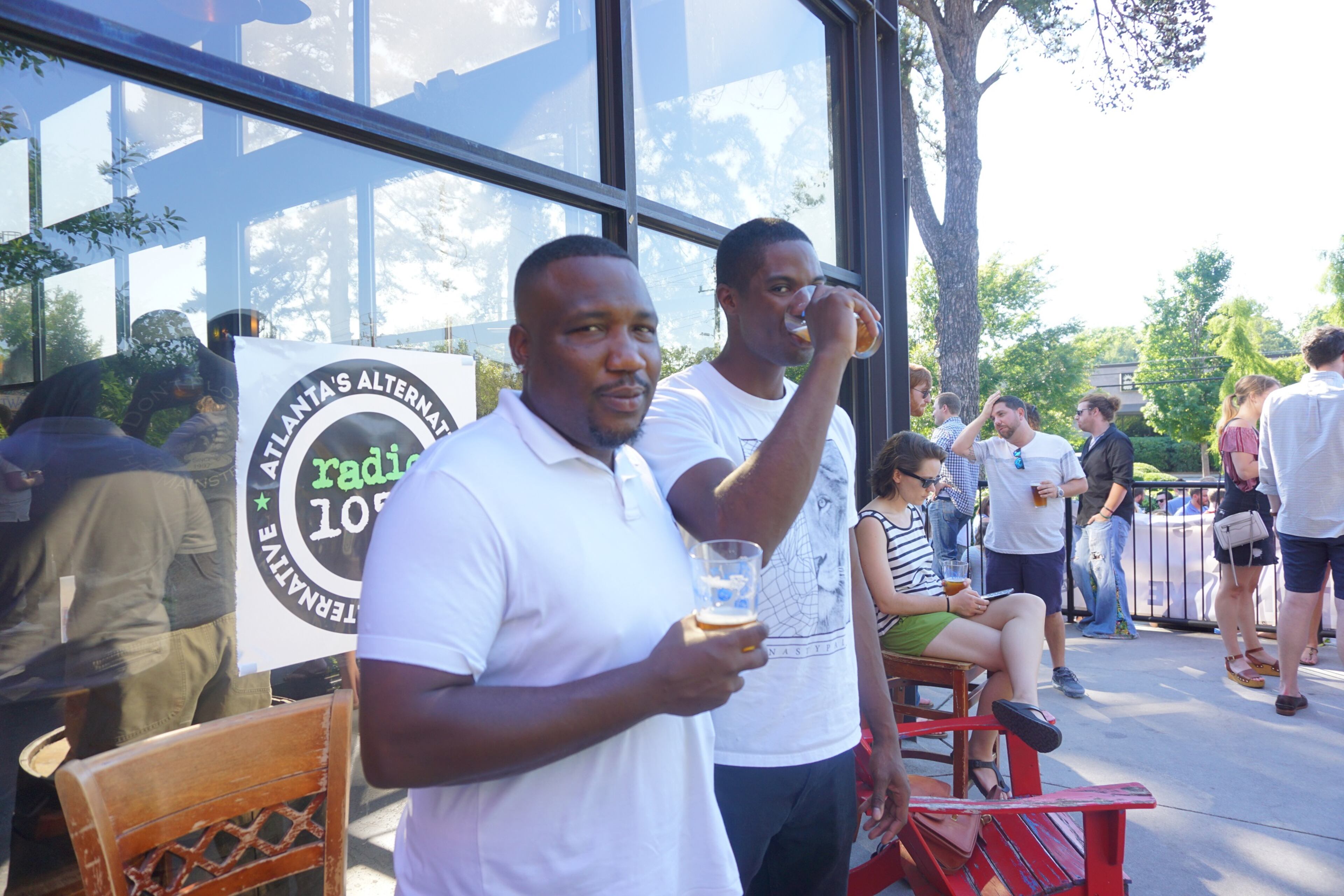 Malik Ashley and Carlos Jordan enjoy some brews during SweetWater's I Survived I-85 party.