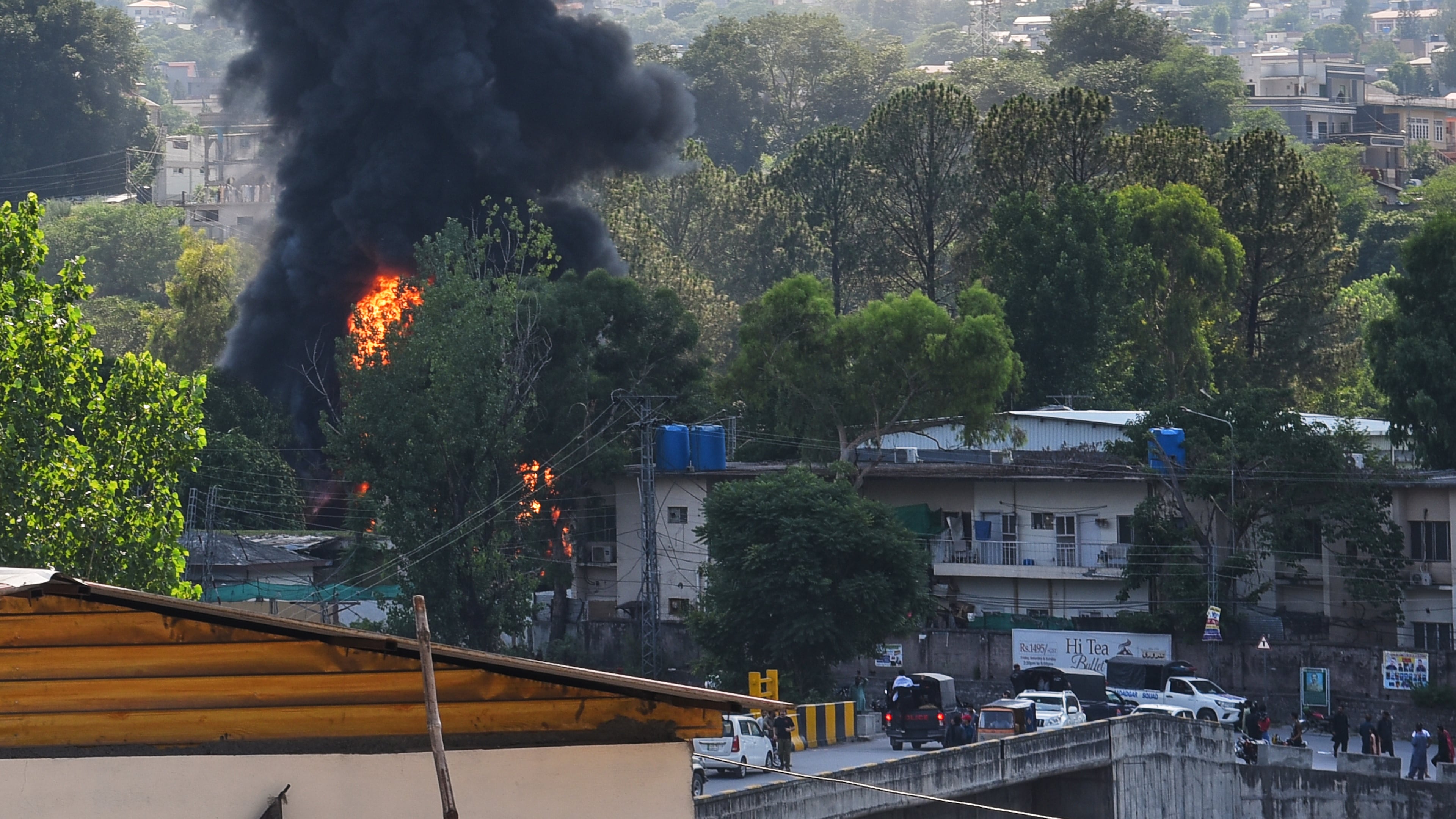 Smoke billows after an army MI-17 helicopter crashed due to a technical fault, in Muzaffarabad, capital of Pakistan-administered Kashmir, Wednesday, June 10, 2026. (AP Photo/M.D. Mughal)