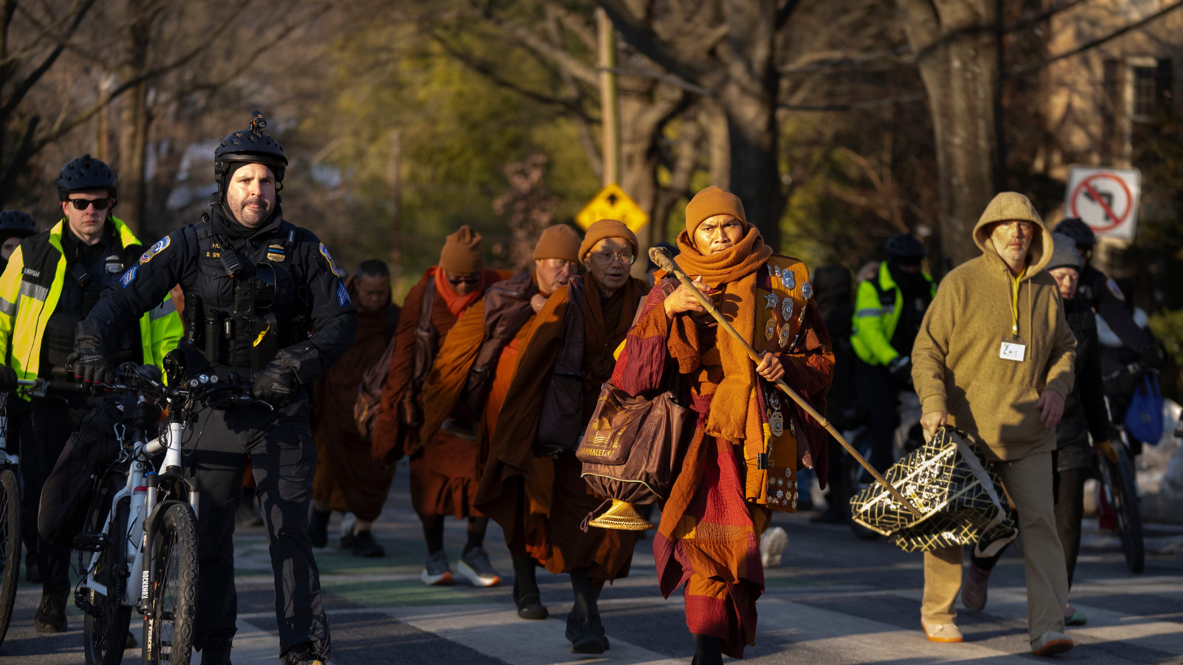 Buddhist monks who are participating in a Walk For Peace walk through a neighborhood on Tuesday, Feb. 10, 2026, in Washington. (AP Photo/Mark Schiefelbein)