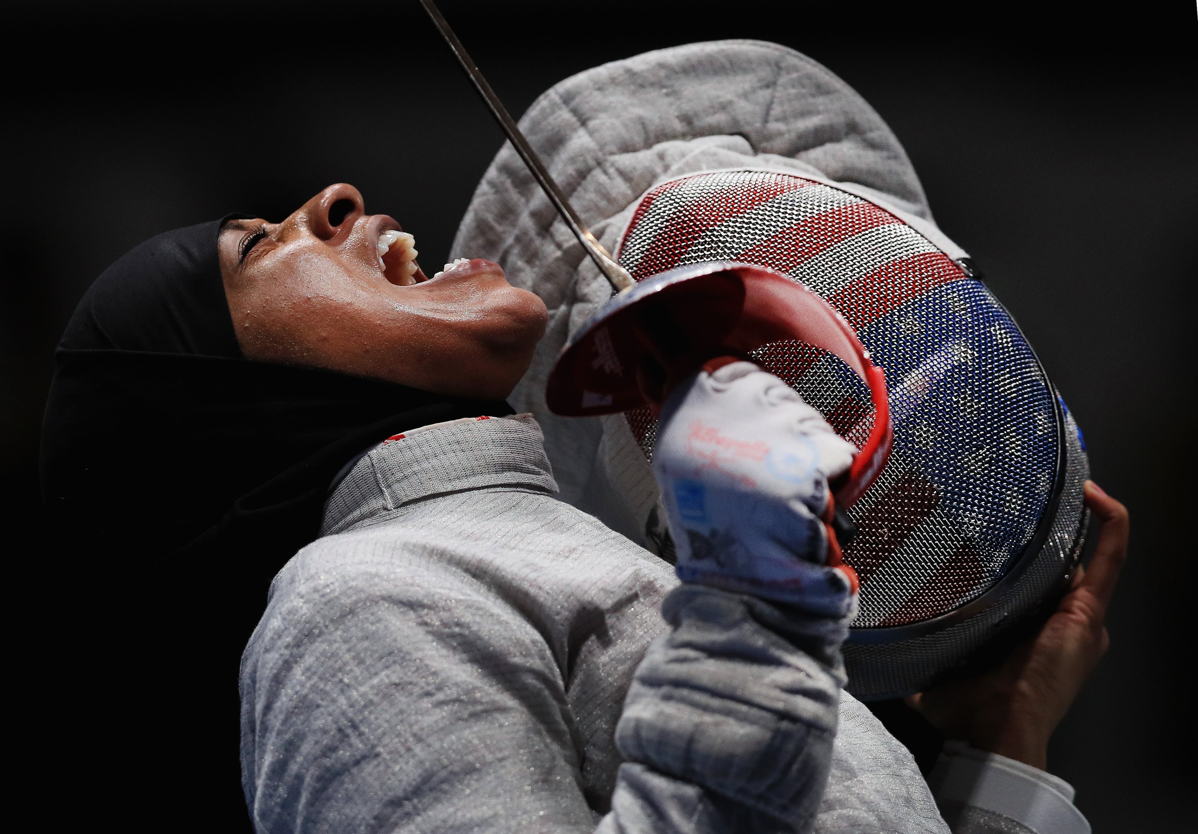 RIO DE JANEIRO, BRAZIL - AUGUST 13: Ibtihaj Muhammad of the United States reacts against Sofya Velikaya of Russia during the Women's Sabre Team Semifinal 1 Russia vs United States at Carioca Arena 3 on August 13, 2016 in Rio de Janeiro, Brazil. (Photo by Tom Pennington/Getty Images)