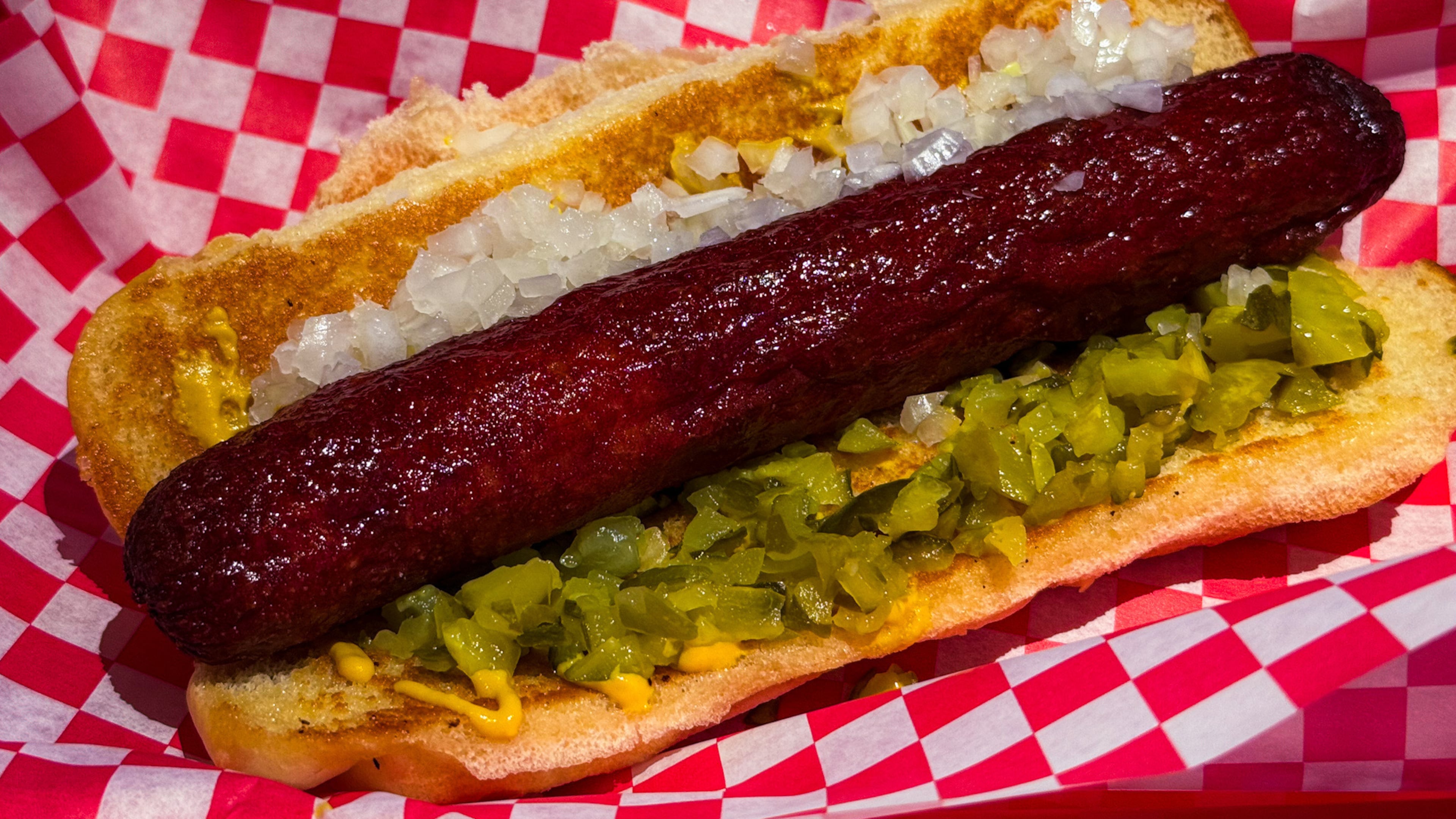 The Southsider, a 1/3-pound Vienna beef hot dog with onions, diced pickles and mustard at NFA Burger. (Henri Hollis /AJC)