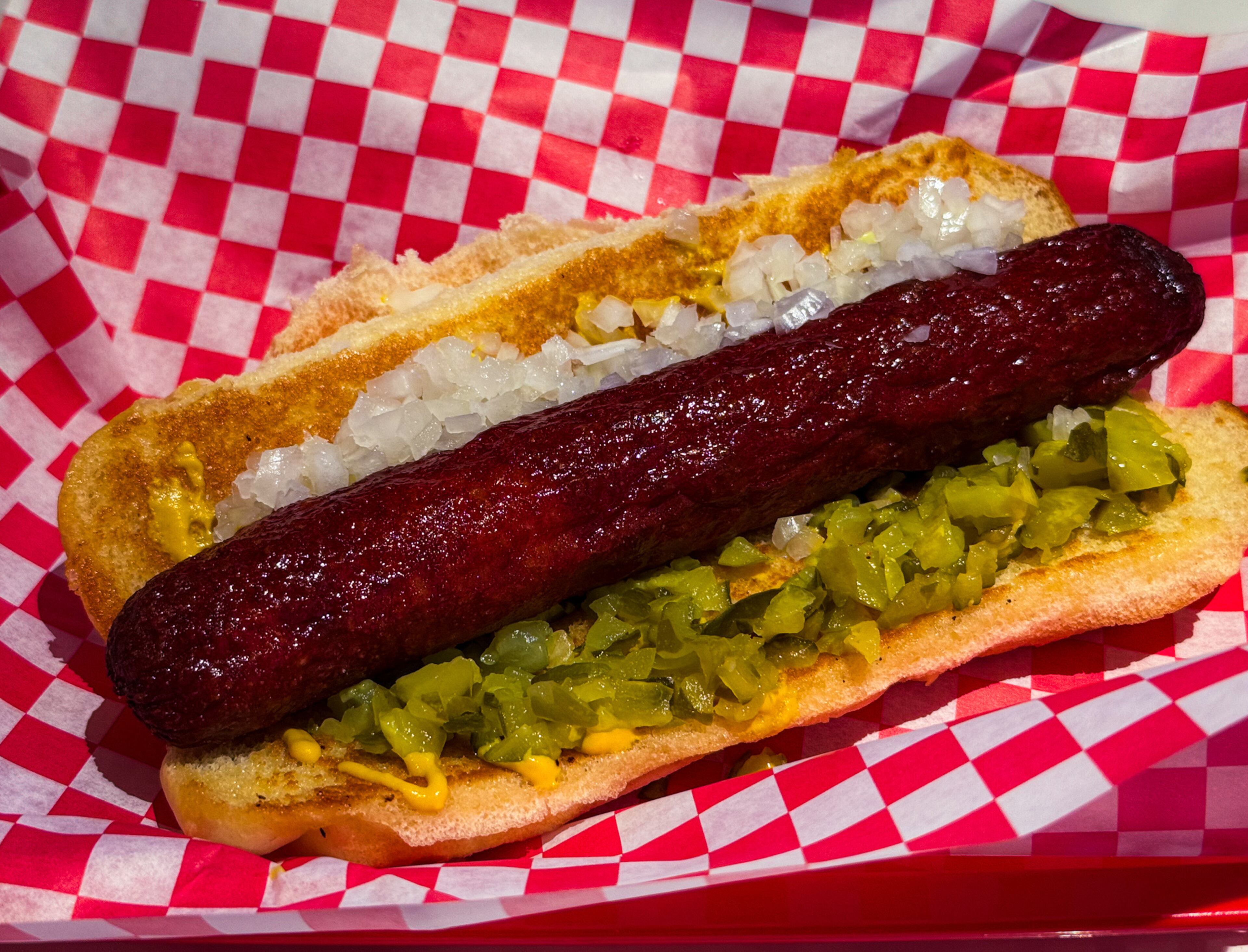 The Southsider, a 1/3-pound Vienna beef hot dog with onions, diced pickles and mustard at NFA Burger Avalon. (Henri Hollis/AJC)