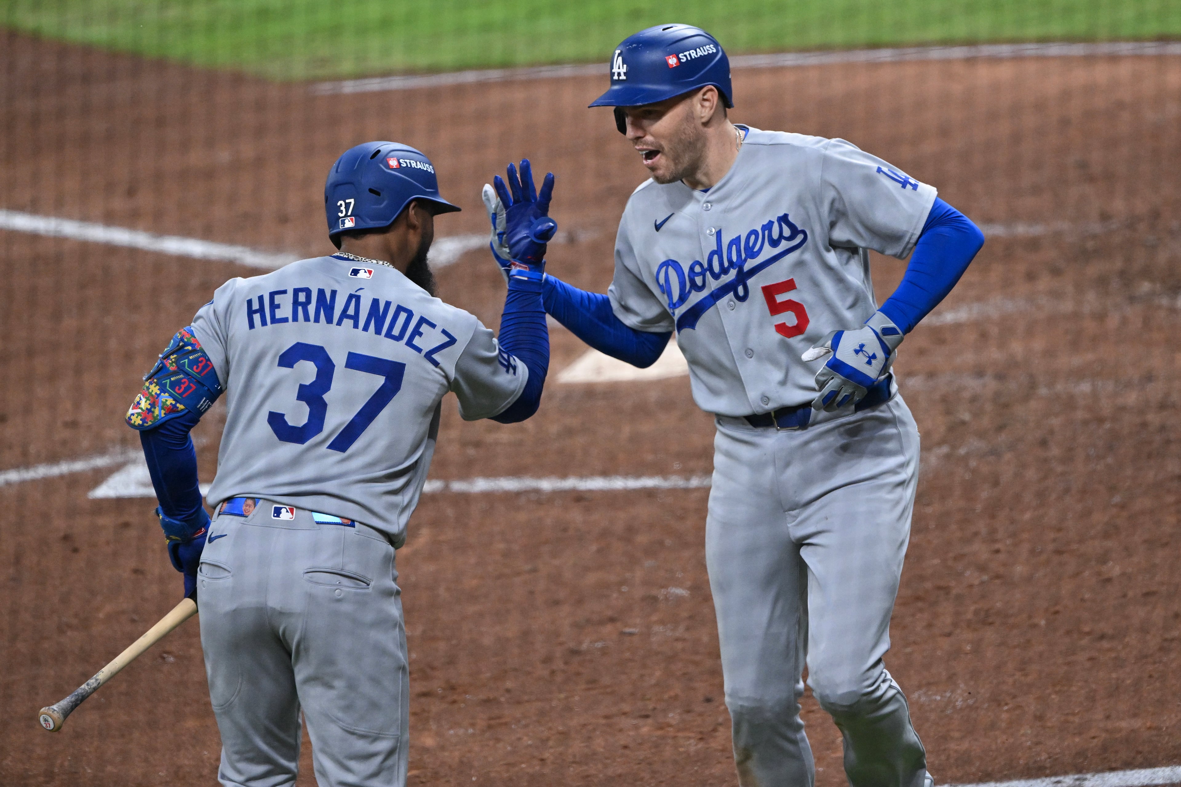 Los Angeles Dodgers' Freddie Freeman (5) reacts with Teoscar Hernandez (37) after hitting a solo home run against the Atlanta Braves during the fourth inning of Game 3 of the MLB National League Division Series between the Atlanta Braves and the Los Angeles Dodgers, Tuesday, Oct. 6, 2026, in Atlanta. (Hyosub Shin/AJC)