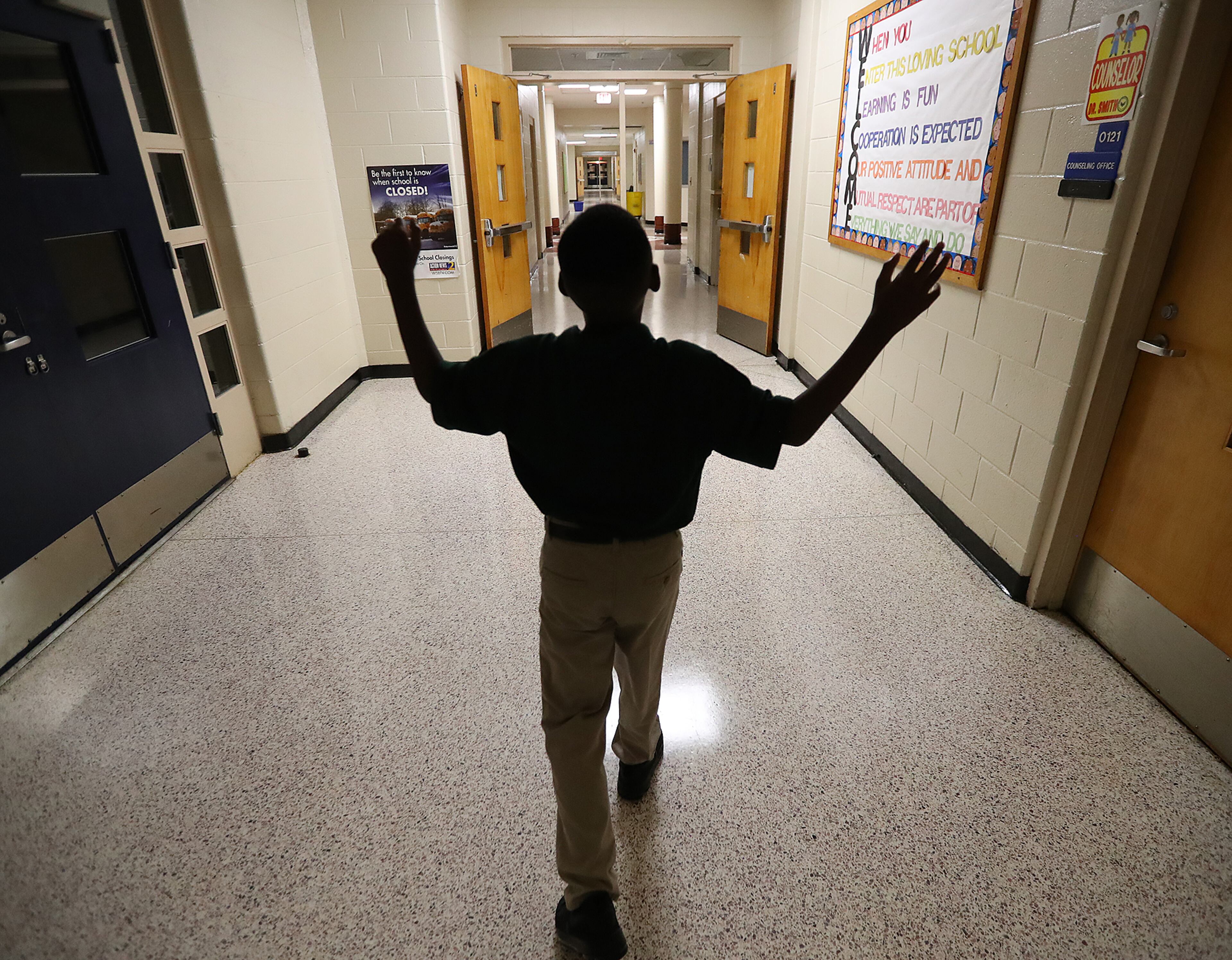 August 7, 2017 Lithonia; Fifth grade student Isaiah Brown, 10, enjoys the freedom of an open hallway as he is the first student to arrive for the first day of school at Edward L Bouie Elementary School on Monday, August 7, 2017, in Lithonia. Curtis Compton/ccompton@ajc.com