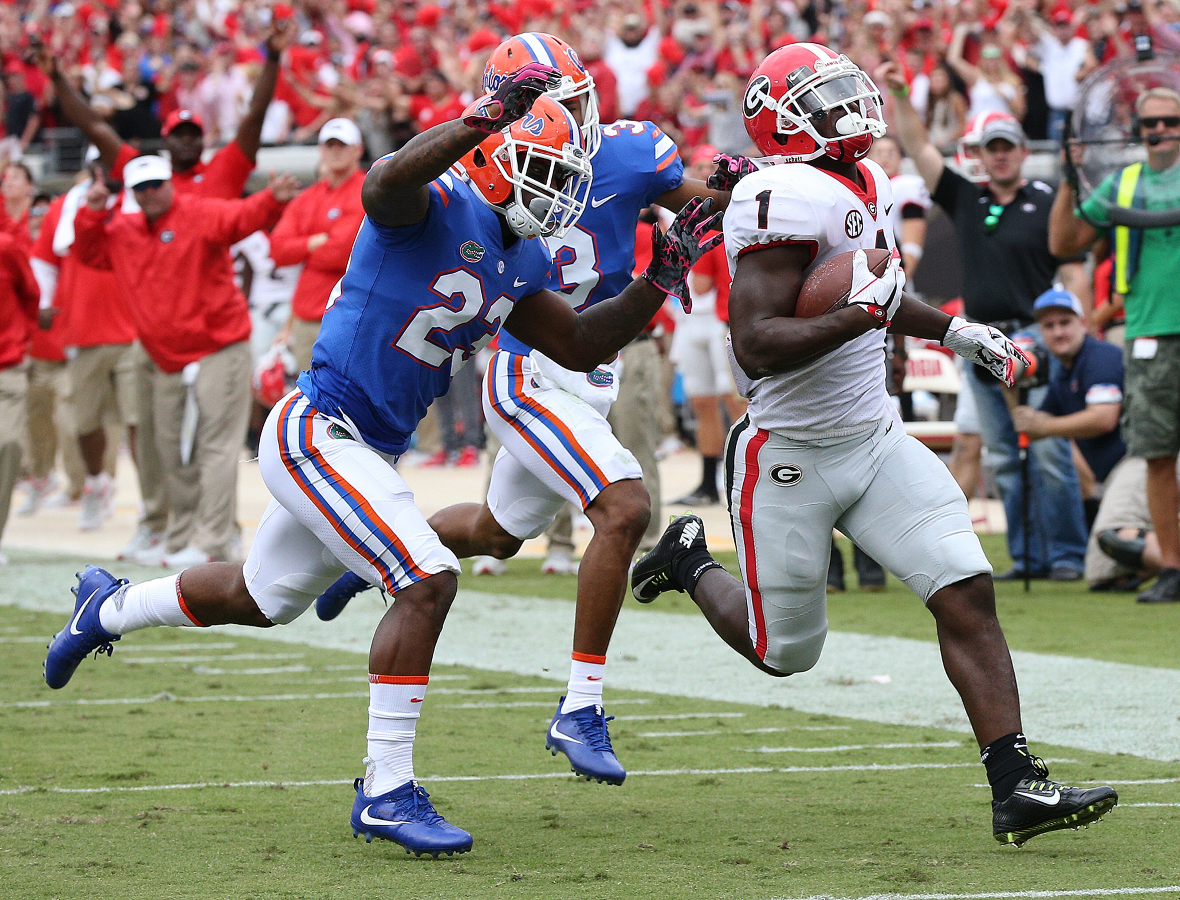 October 28, 2017 Jacksonville: Georgia tailback Sony Michel gets past Florida defenders on a long touchdown run to take a 21-0 lead during the first quarter in a NCAA college football game on Friday, October 27, 2017, in Jacksonville. Curtis Compton/ccompton@ajc.com