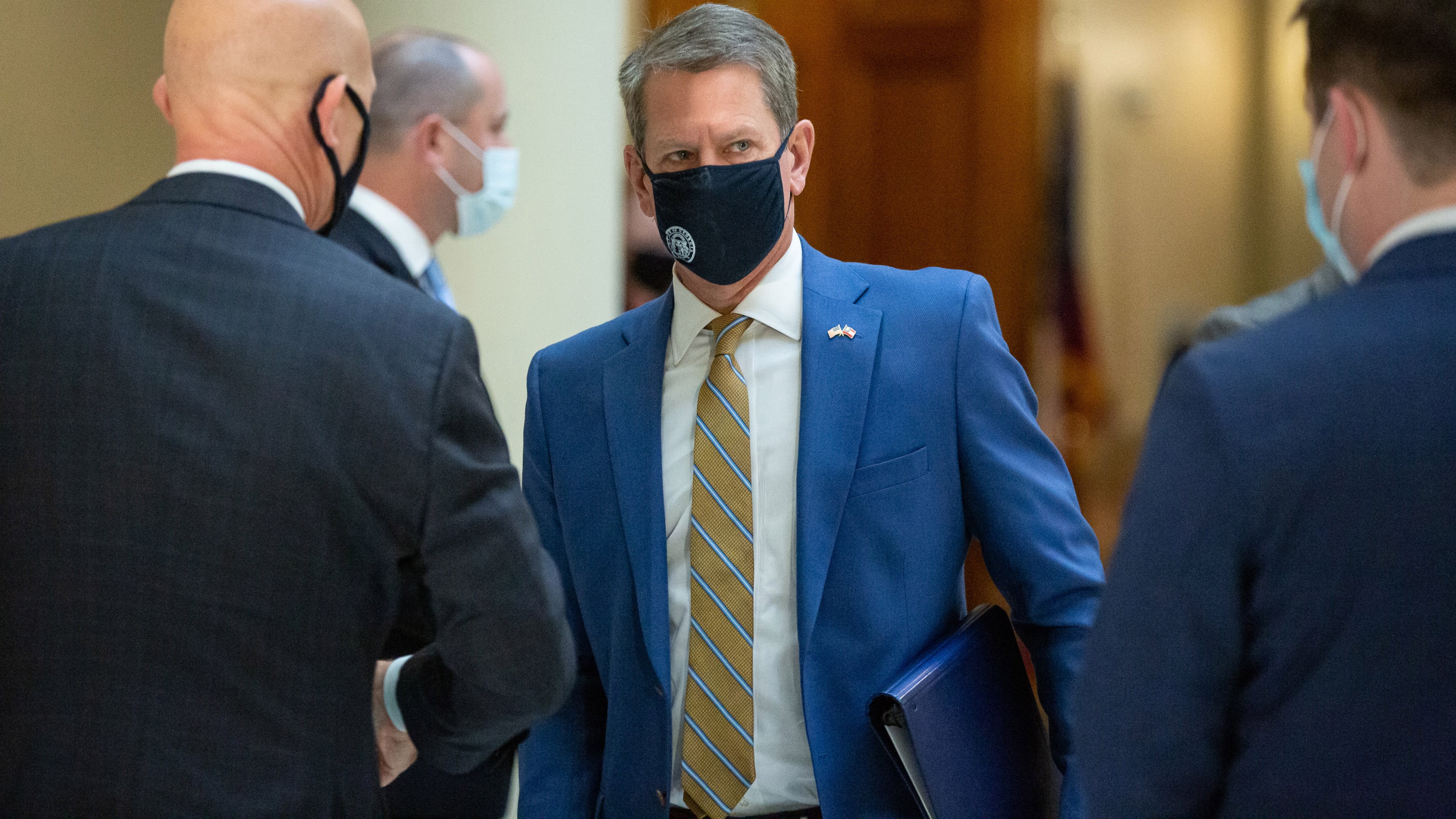 Governor Brian P. Kemp (C) talks with GBI Director Vic Reynolds (L) after a press conference at the State Capital Tuesday, November 24, 2020. STEVE SCHAEFER / SPECIAL TO THE AJC