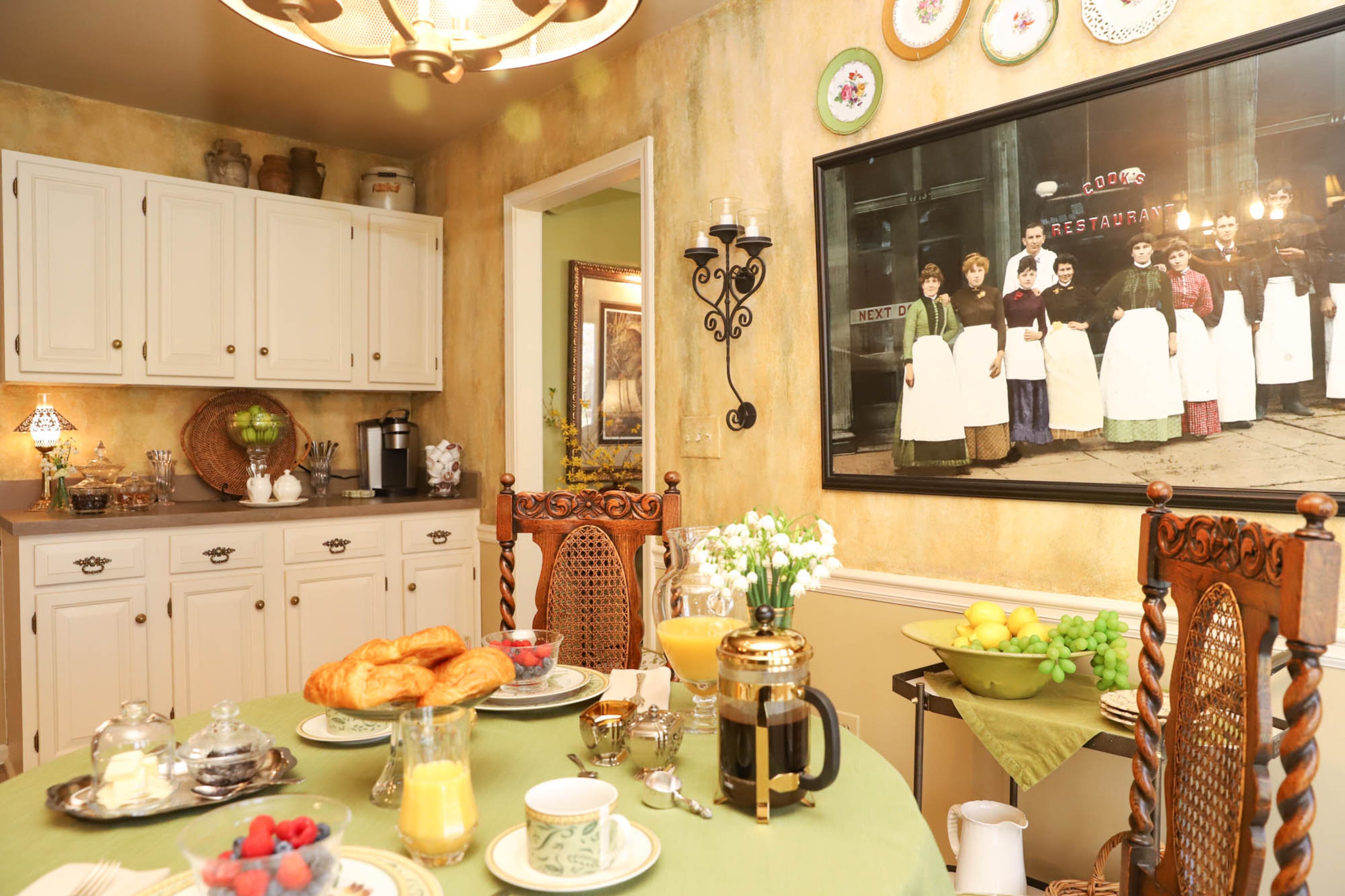 A large framed photograph picturing a kitchen staff in front of a building labeled “Cook’s Restaurant” hangs in Susan and Dennis Cook’s kitchen. They purchased it from a location of Cooker Bar & Grille, which had it as wall decor in the restaurant. Text by Shannon Dominy/Photo by Reynolds Rogers