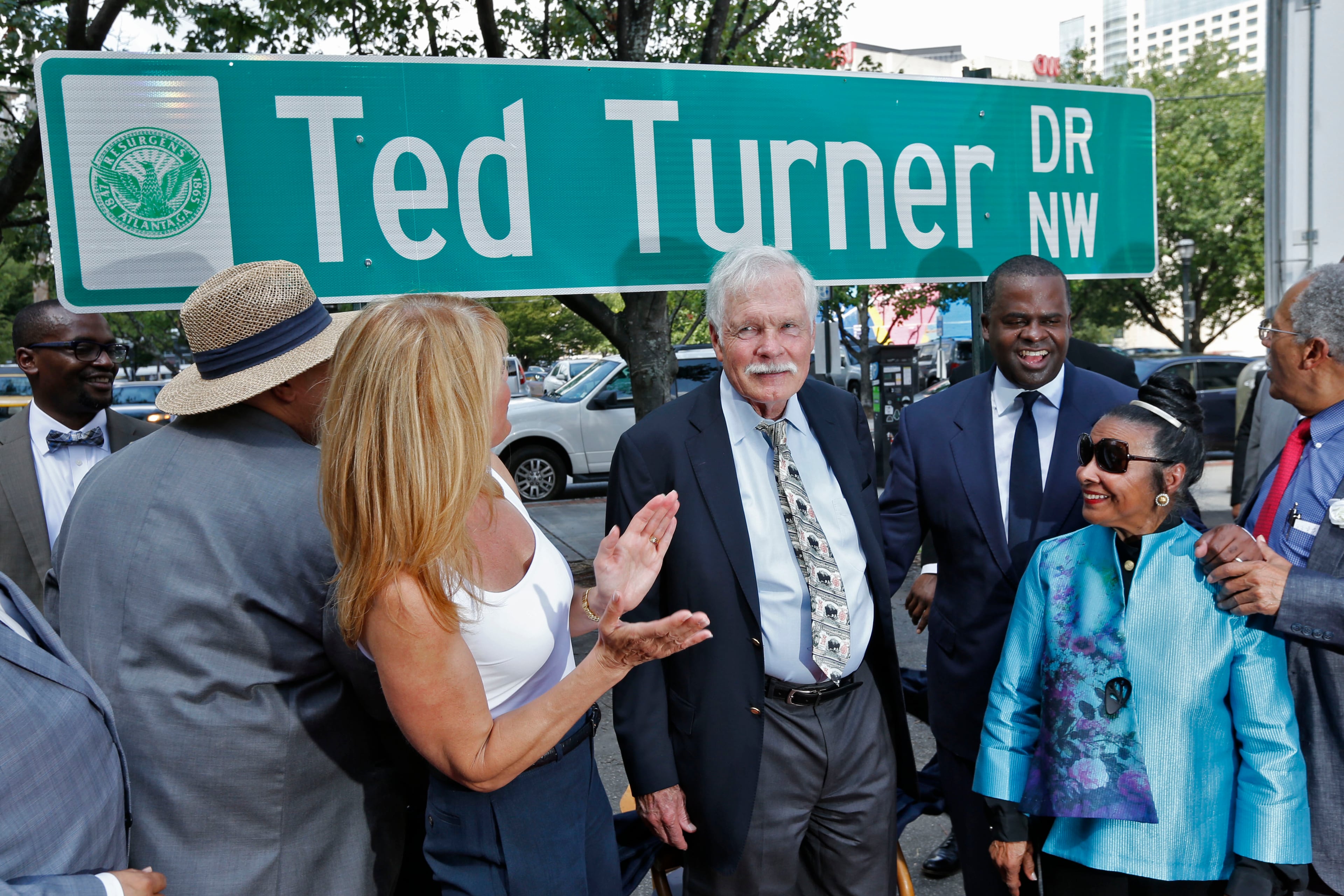 With City Council members, Mayor Reed, Ted Turner's daughter Laura Turner Seydel, and Xernona Clayton around him, Ted Turner was honored with the unveiling of Ted Turner Dr. on Tuesday, July 21, 2015. The renamed portion of Spring Street between Whitehall Street and West Peachtree Street is near the area where Turner established some of his most prominent business endeavors, including Turner Broadcasting System (TBS) and the CNN Headquarters. BOB ANDRES / BANDRES@AJC.COM