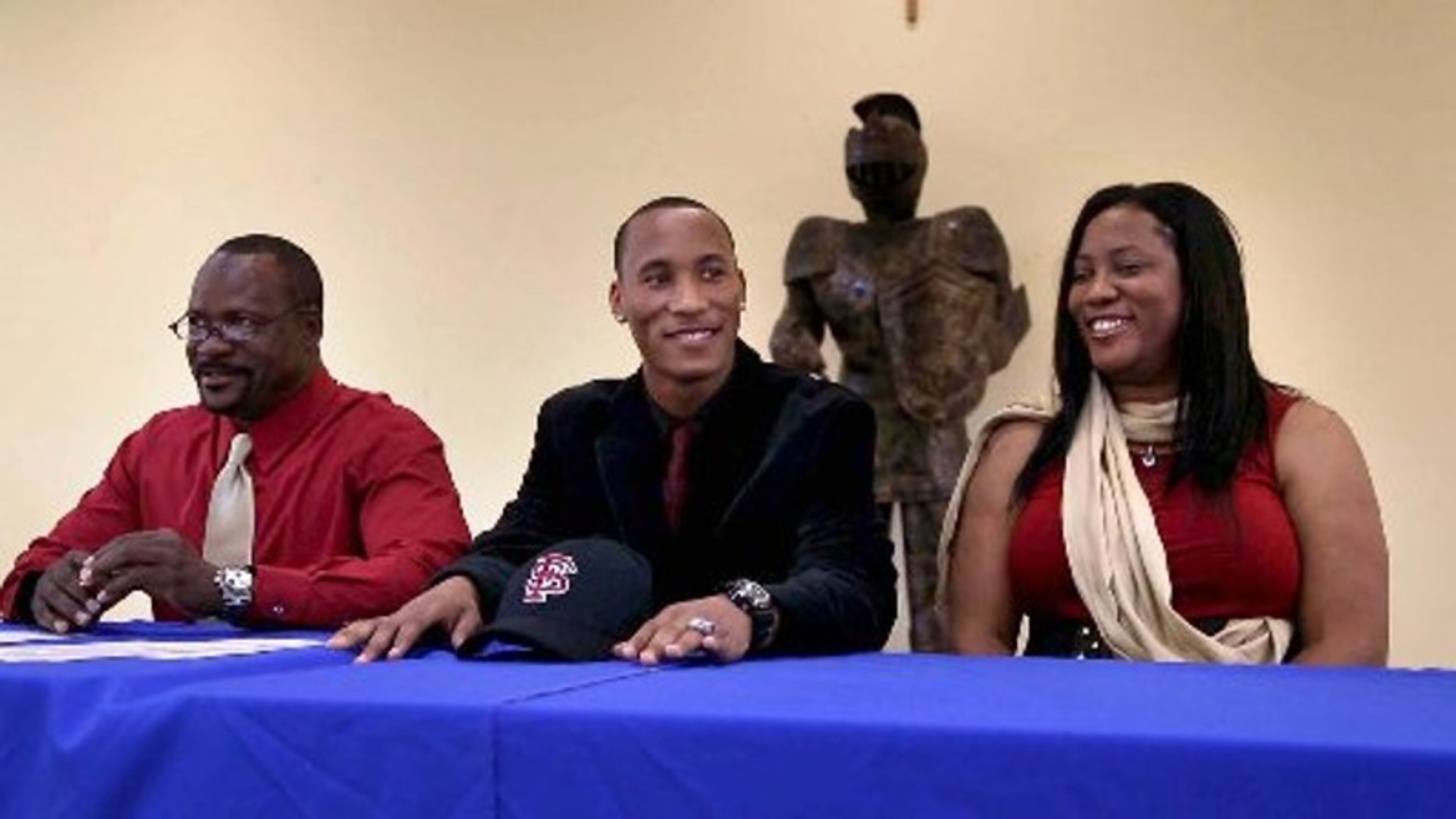 Wide receiver Travis Rudolph was flanked by his parents, Darryl and Linda, when he signed with Florida State in 2014. Darryl Rudolph was killed Saturday in an accidental shooting, according to authorities.