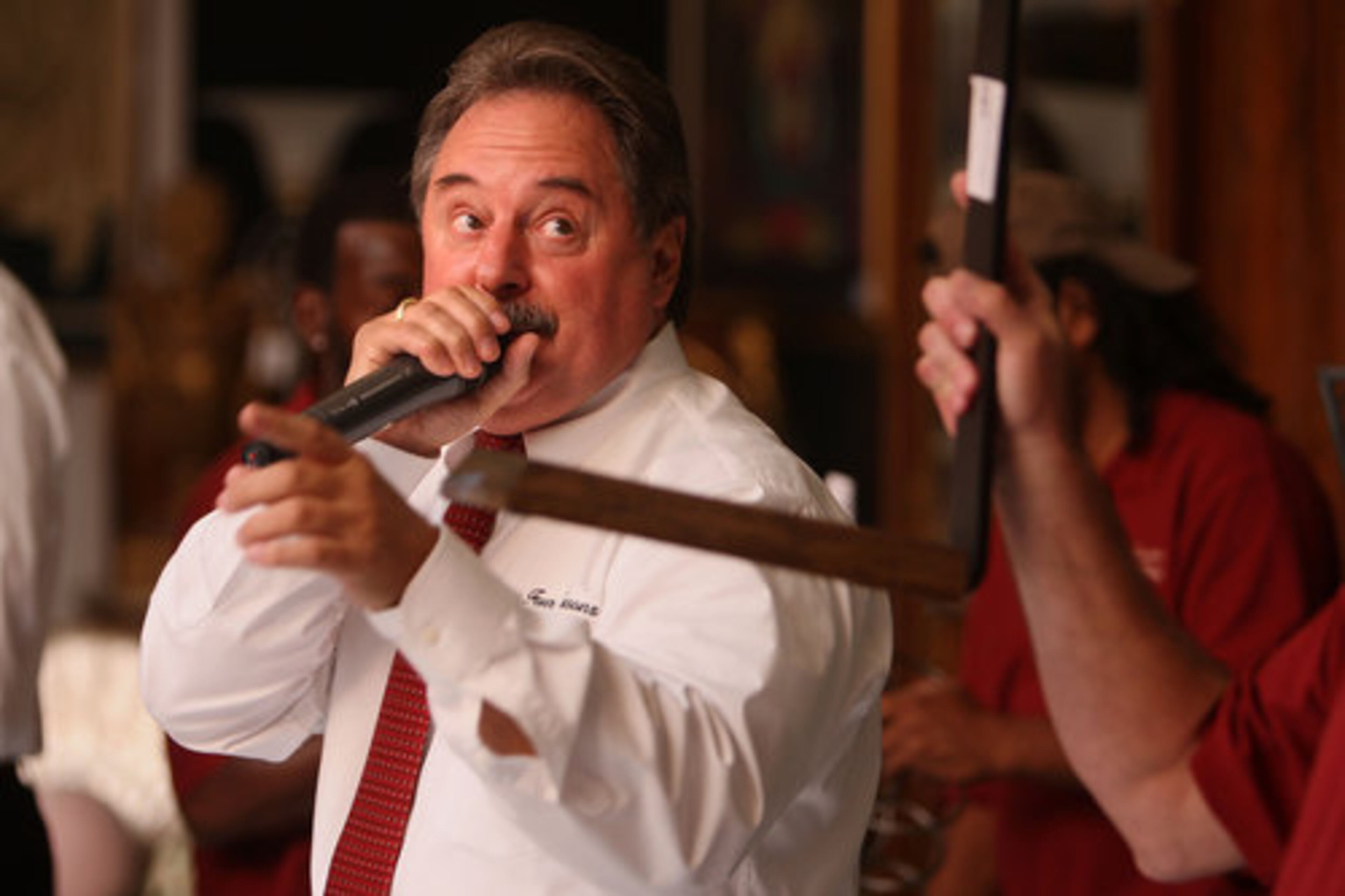 Steve White of Four Seasons Auction Gallery starts the live auction at Dean Gardens on Sunday, Sept. 12, 2010. Perry bought the property for $7.6 million in late July and will demolish it.