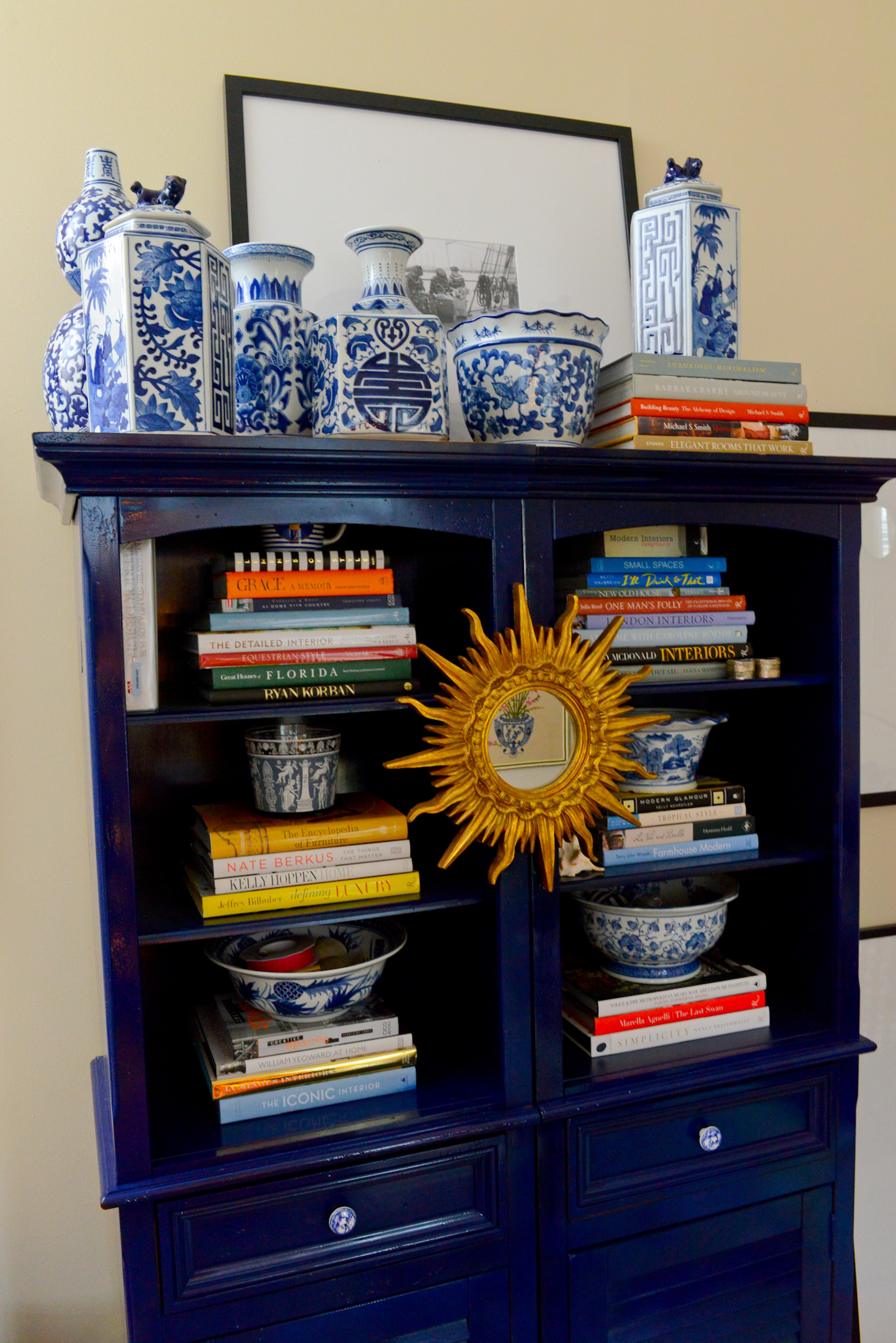 Travis Snyder combs shops, including the Goodwill of North Georgia in Buckhead and Queen of Hearts Antiques and Interiors in Alpharetta, for furniture, such as this armoire and mirror, with potential. He then paints or reupholsters them in vibrant colors for his Union City home. The vases are from HomeGoods.
