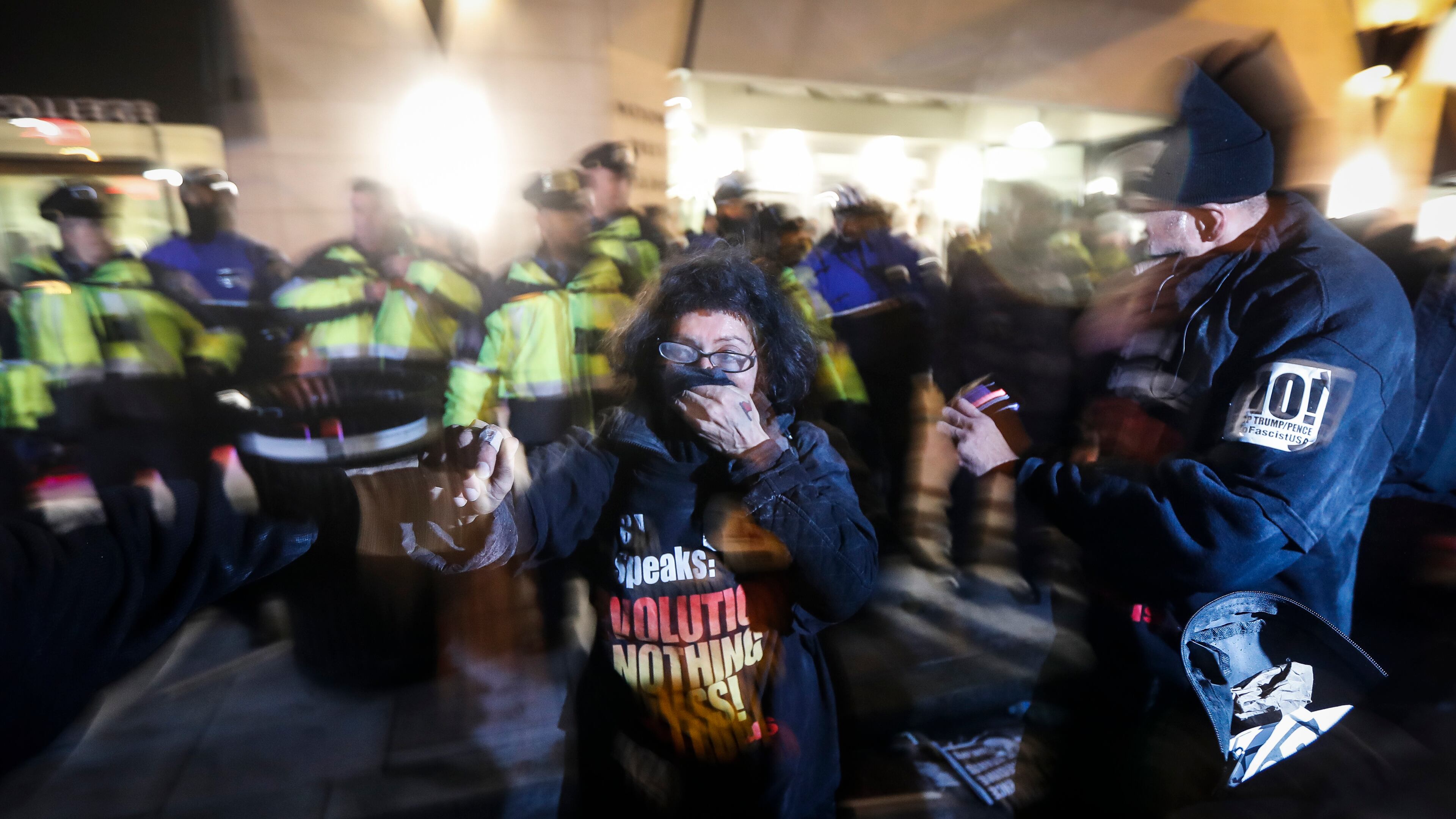 Protesters cover their faces after being pepper sprayed following a scuffle outside the National Press Club ahead of the presidential inauguration, Thursday, Jan. 19, 2017, in Washington. (AP Photo/John Minchillo)
