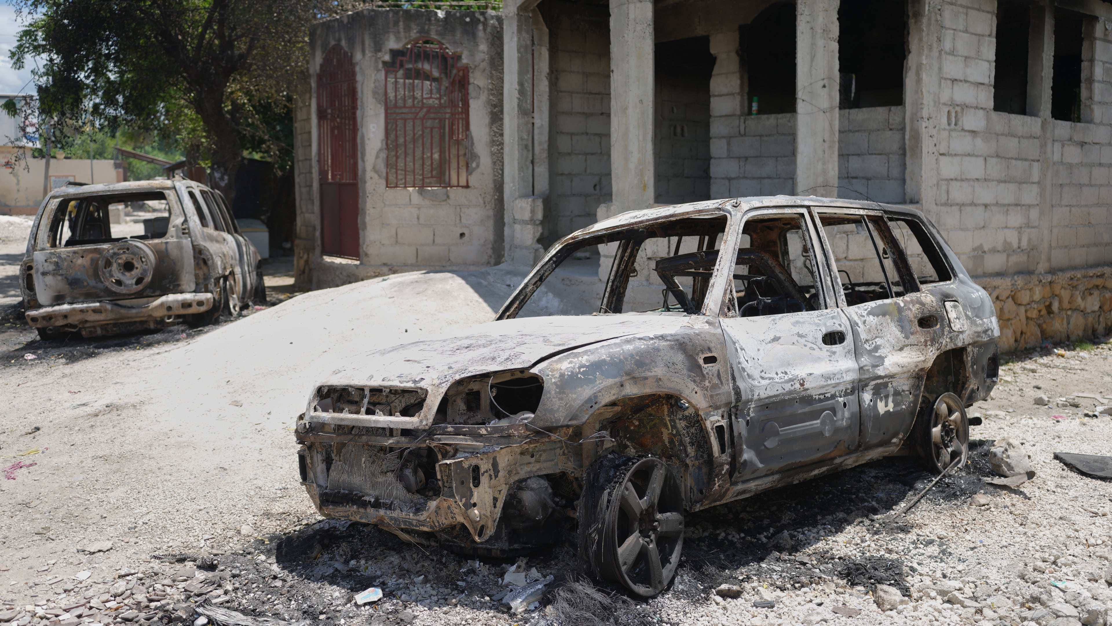 FILE - Vehicles that were set on fire by armed gangs sit in the Cite Soleil neighborhood of Port-au-Prince, Haiti, May 12, 2026. (AP Photo/Odelyn Joseph, File)