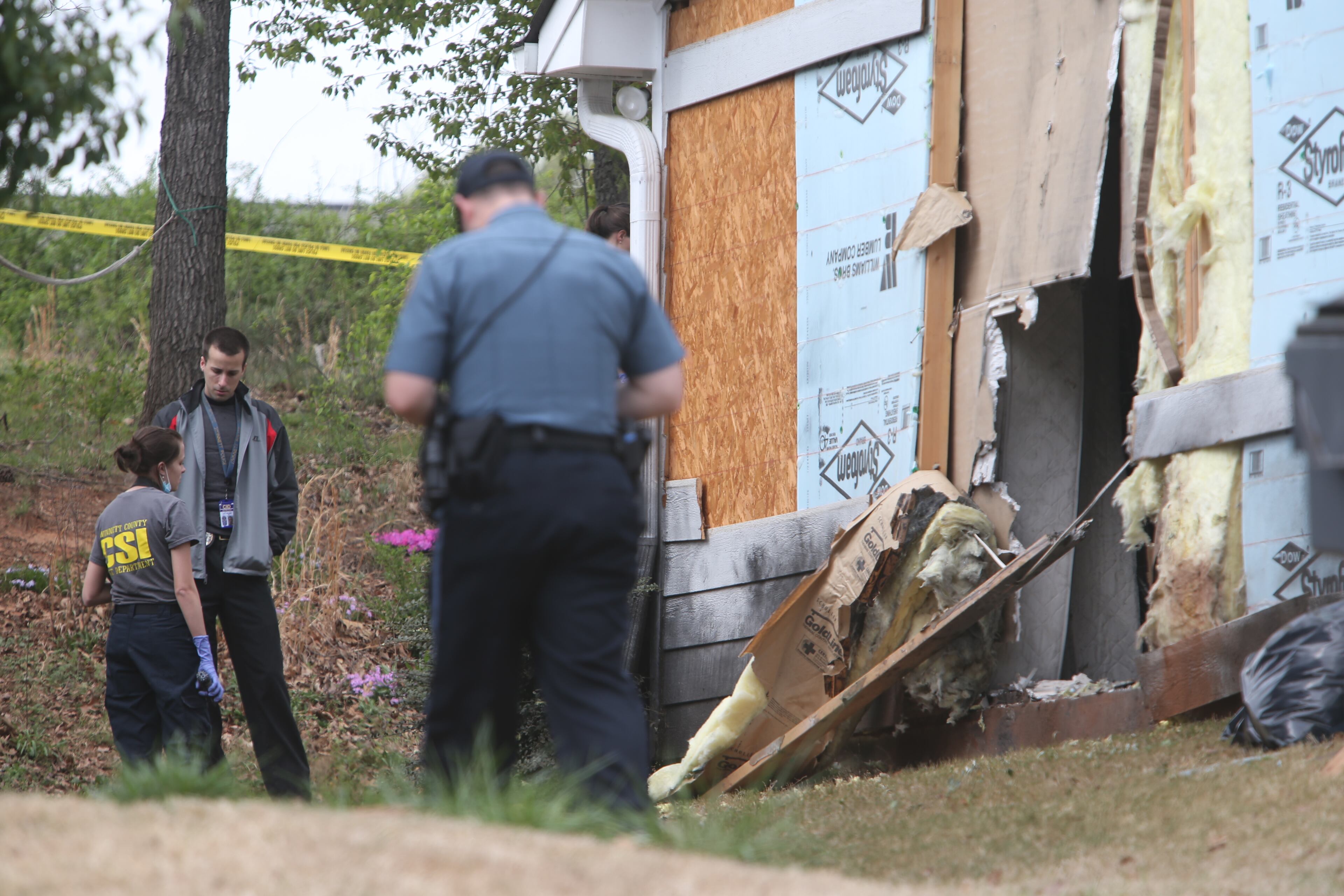 This Thursday, April 11, 2013 photo shows a home damaged during a hostage standoff in Suwanee. Lauren Brown, 55, was killed after holding four Gwinnett County firefighters hostage for hours before they where freed when police officers stormed the house Wednesday.