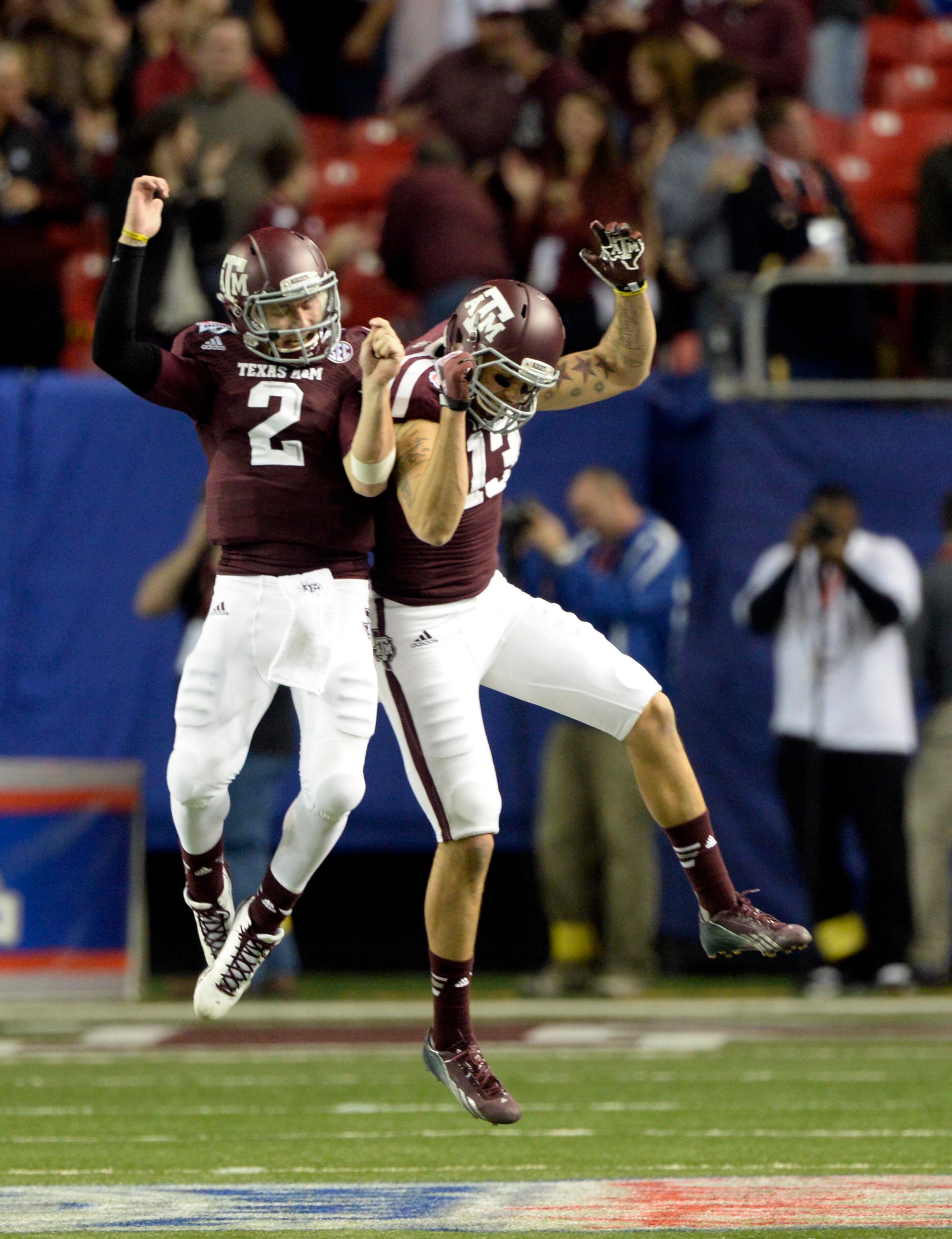 Texas A&M Aggies quarterback Johnny Manziel (2) celebrates with wide receiver Mike Evans (13) in the fourth quarter against the Duke Blue Devils in the 2013 Chick-fil-a Bowl at the Georgia Dome.