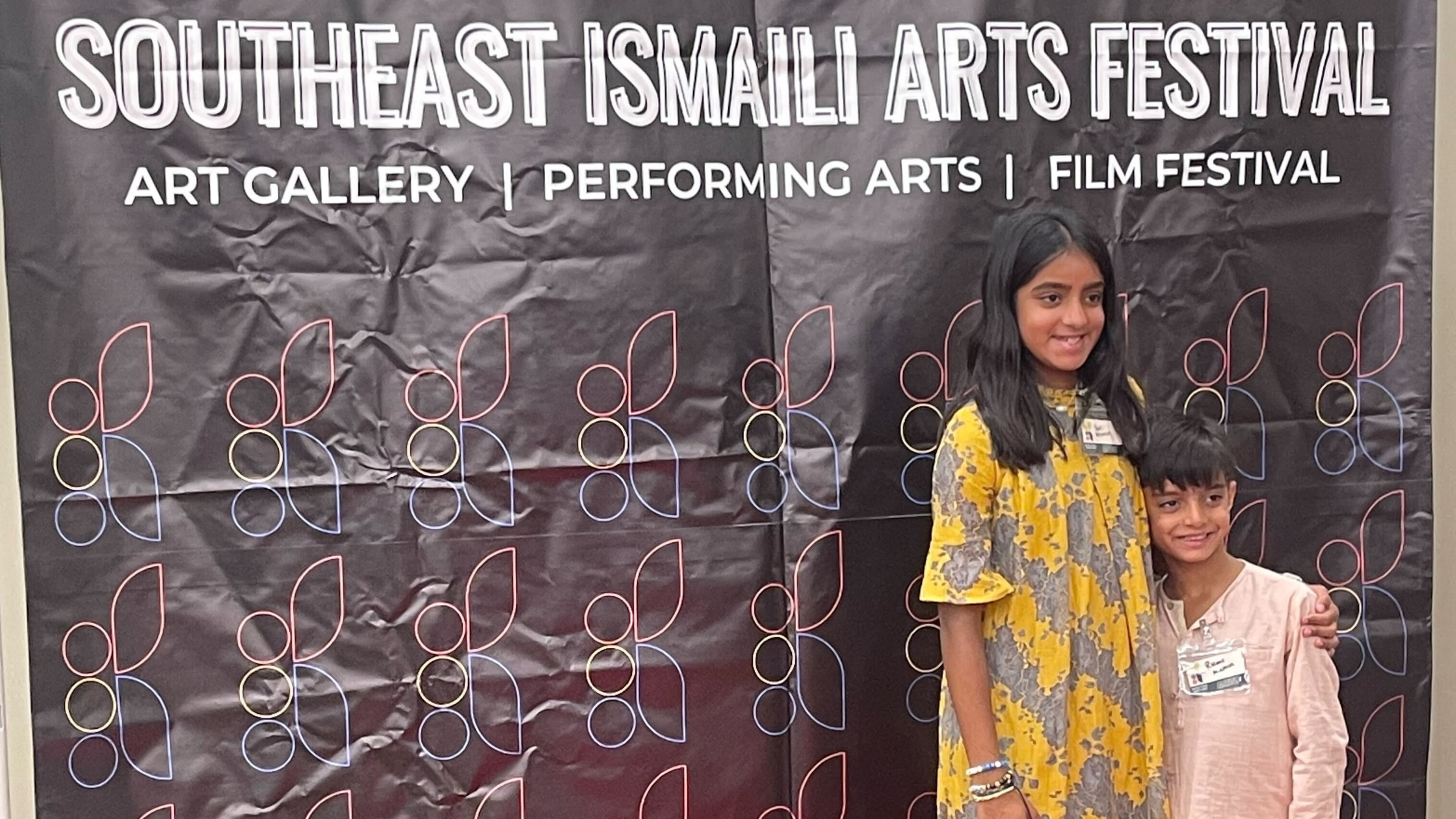 Sufi Momin, 12, poses with her brother Rumi at a Southeast Ismaili Arts Festival event. Sufi created a short documentary about biodiversity and climate change that will be screened Sept. 16 at the festival held at the Rialto Center for Performing Arts at Georgia State University. (Courtesy of Behnoosh Momin)
