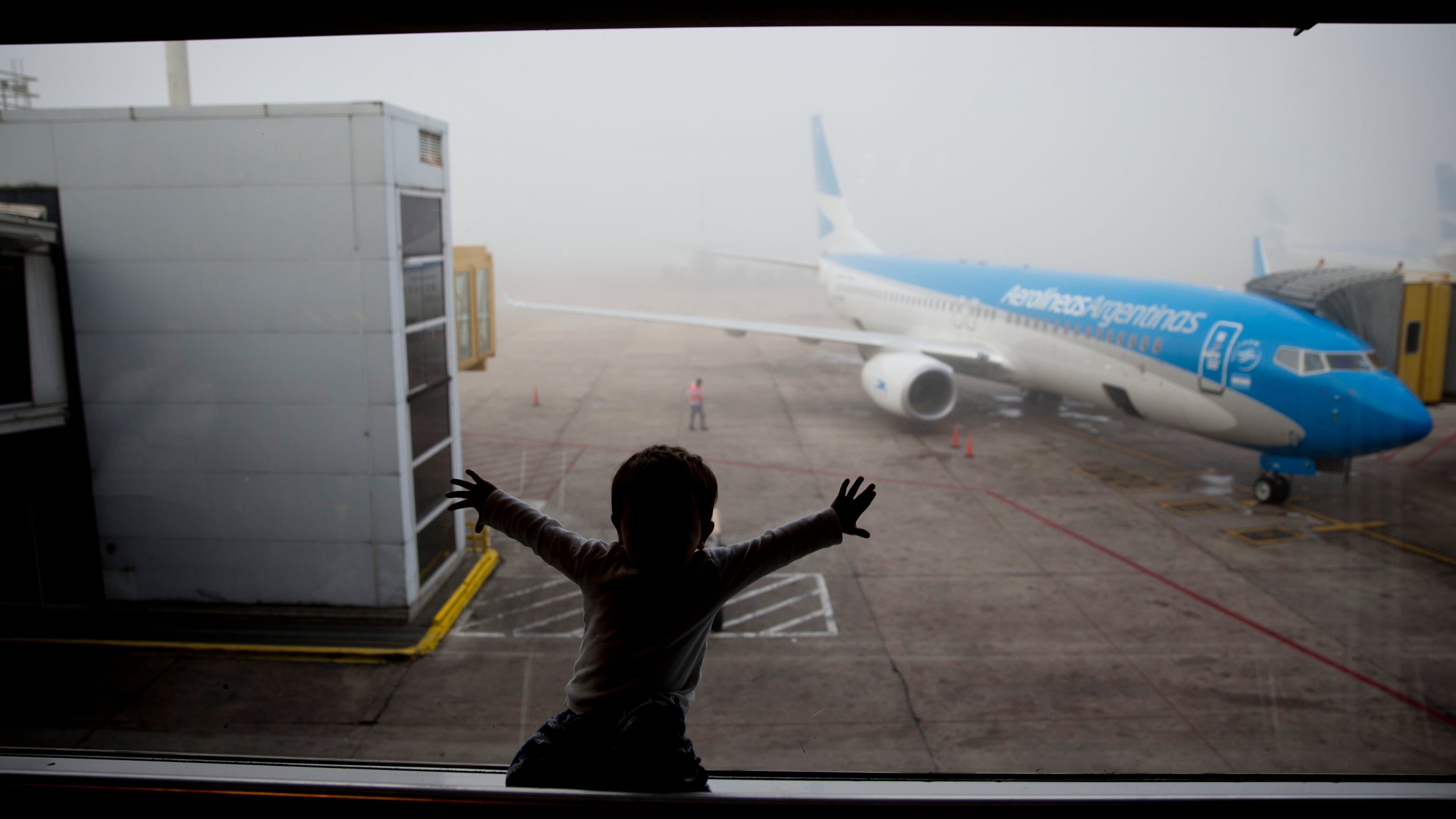 FILE - A child watches a plane at the Jorge Newbery airport in Buenos Aires, Argentina, April 14, 2016. (AP Photo/Natacha Pisarenko, File)