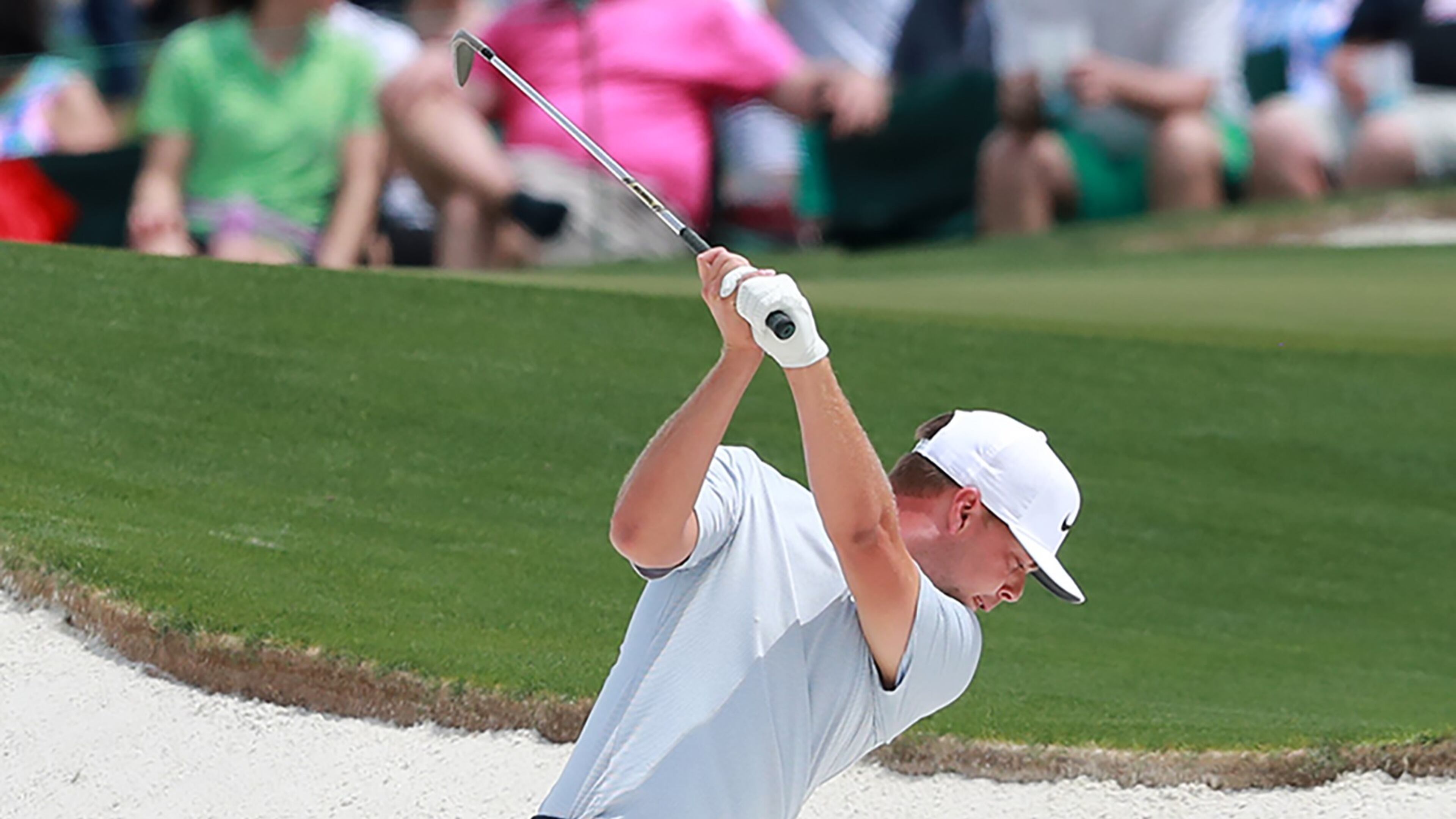 Keith Mitchell hits out of the bunker to the 18th green during his practice round for the Masters at Augusta National Golf Club on Monday, April 8, 2019, in Augusta. Curtis Compton/ccompton@ajc.com