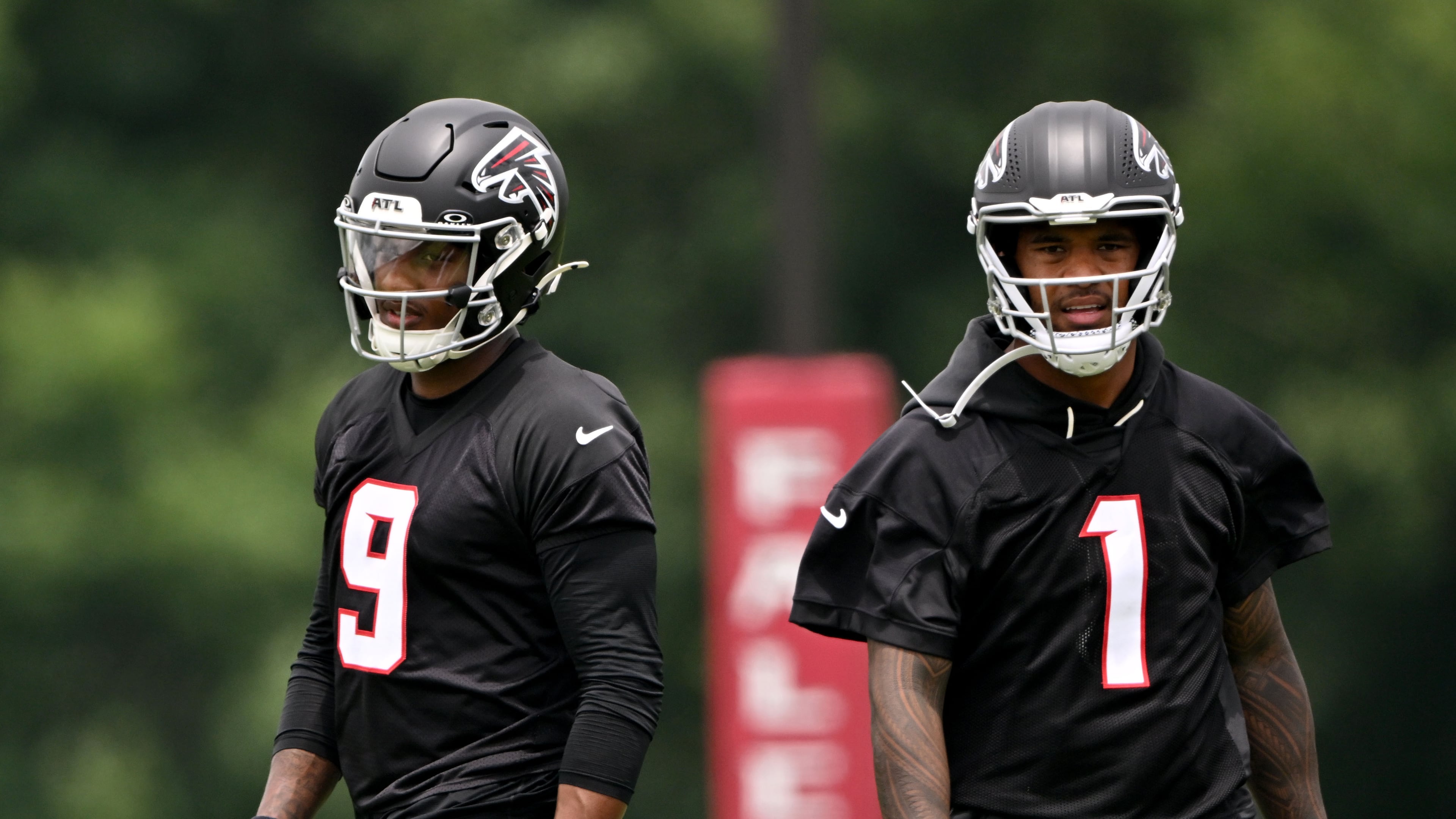 Falcons quarterbacks Michael Penix Jr. (left) and Tua Tagovailoa run drills during an OTA workout at the team's training facility Wednesday, May 27, 2026, in Flowery Branch. (Hyosub Shin/AJC)