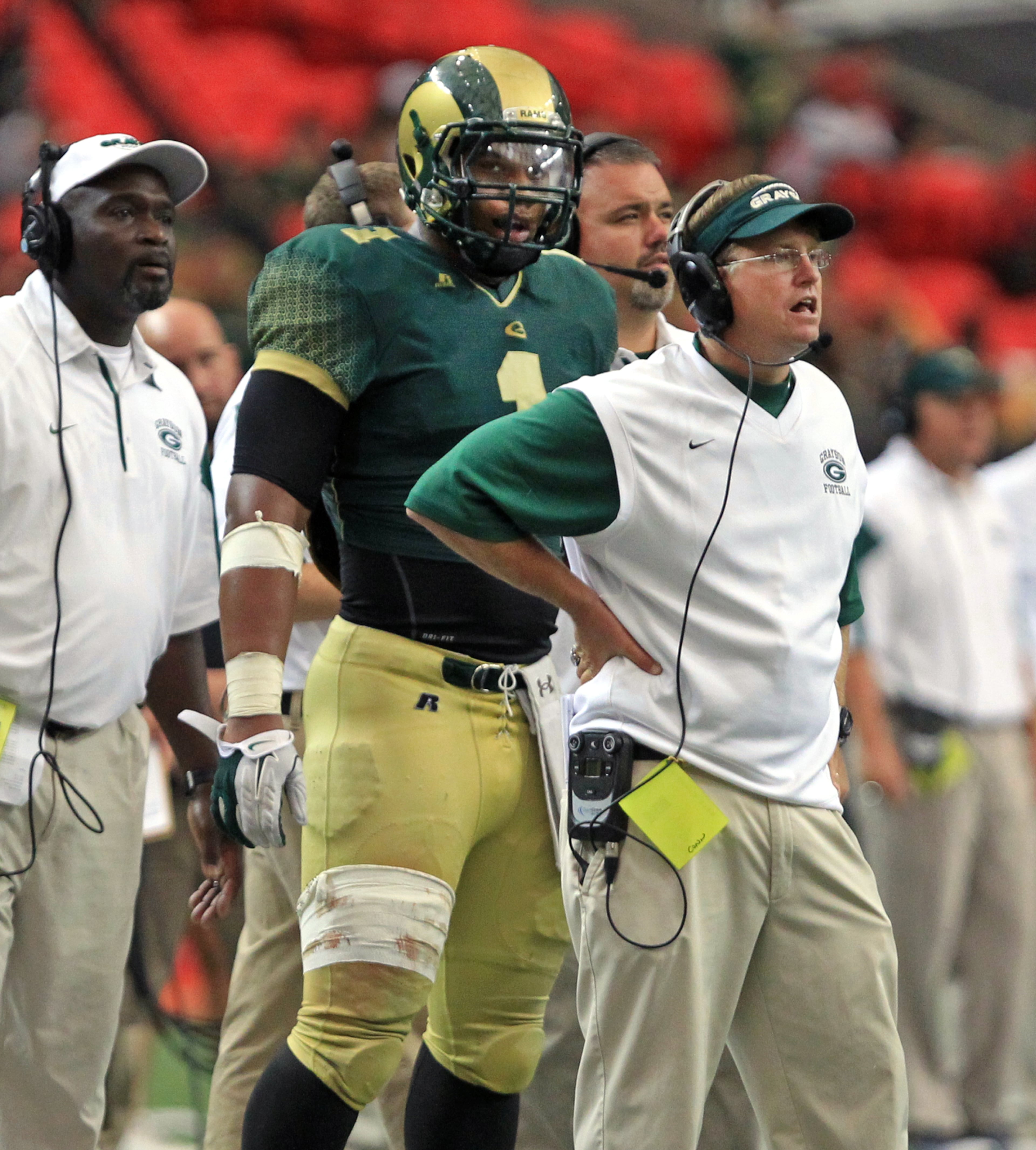 Grayson defensive end / running back Robert Nkemdiche (1) stands behind head coach Mickey Conn.