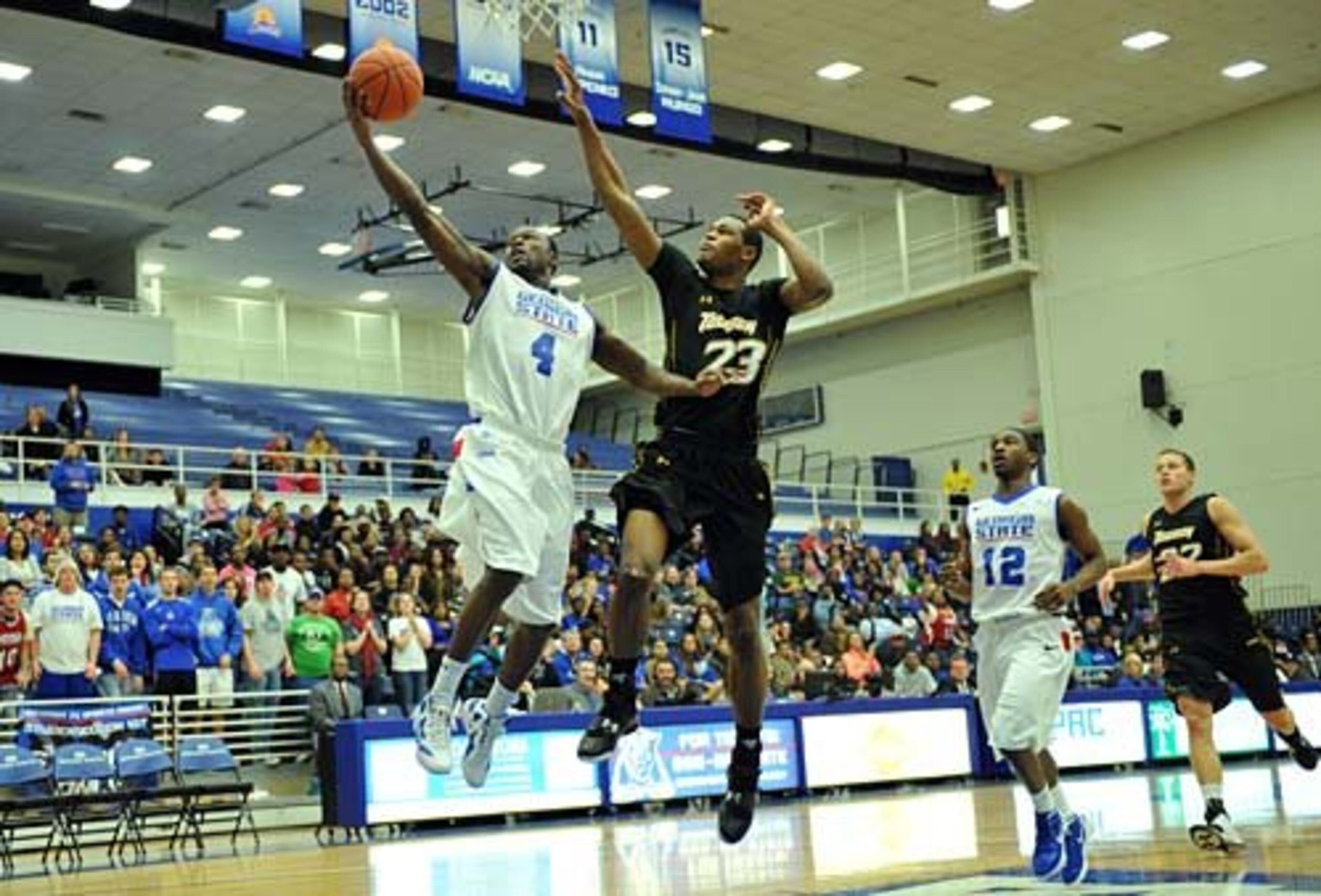 James Fields (4) goes to the basket as Towson forward Deon Jones (23) tries to stop him.