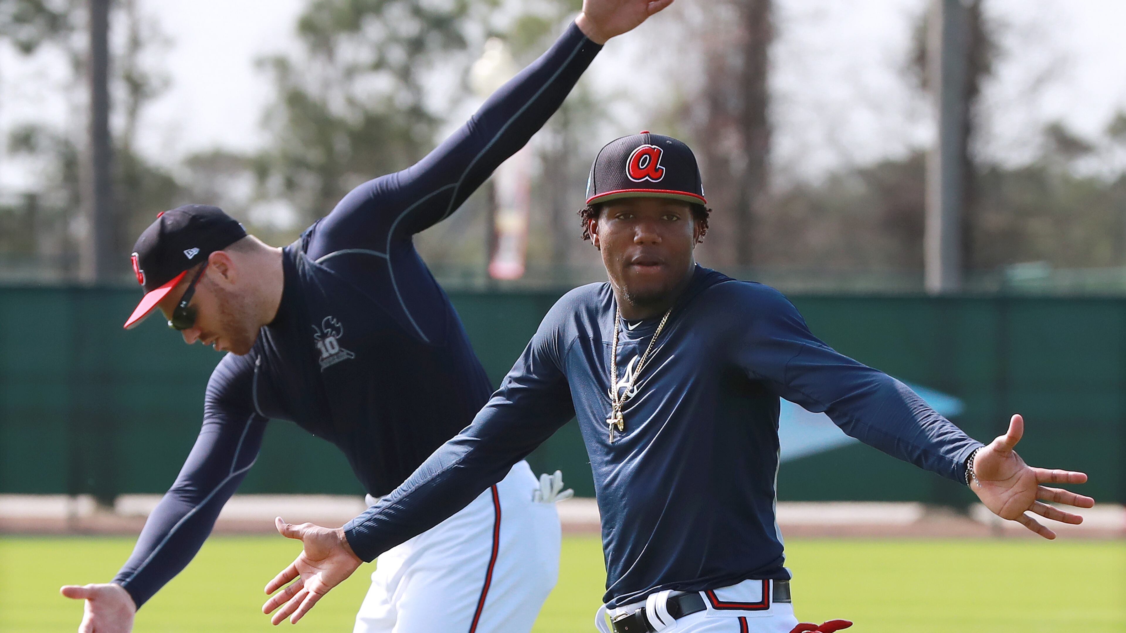 Atlanta Braves first baseman Freddie Freeman (background) and outfielder Ronald Acuna loosen up for another day of spring training Tuesday, Feb. 19, 2019, at the ESPN Wide World of Sports Complex in Lake Buena Vista, Fla. Full squad workouts begin Thursday.