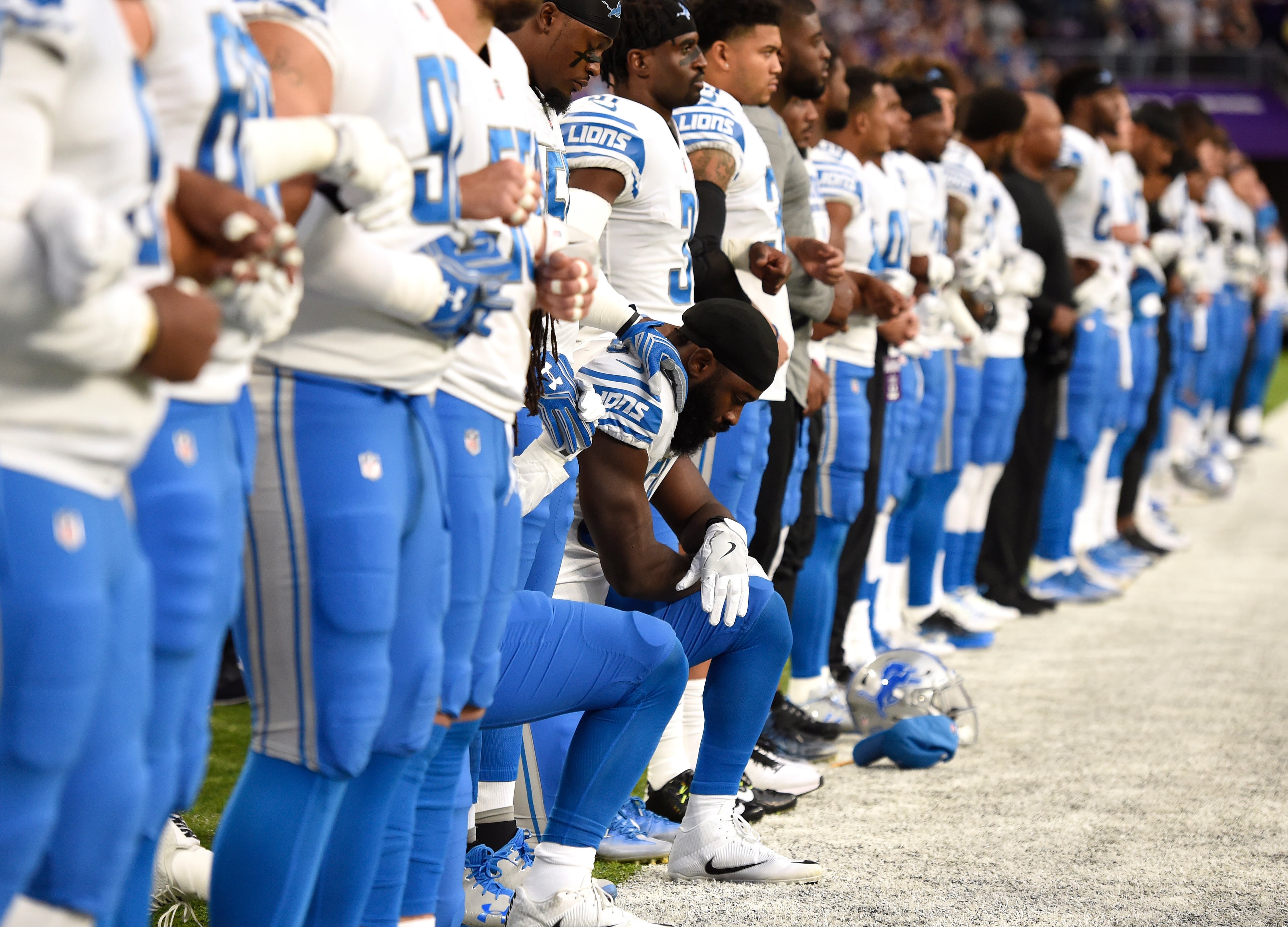 MINNEAPOLIS, MN - OCTOBER 1: Steve Longa #54 of the Detroit Lions takes a knee with teammate Jalen Reeves-Maybin during the national anthem before the game against the Minnesota Vikings on October 1, 2017 at U.S. Bank Stadium in Minneapolis, Minnesota. (Photo by Hannah Foslien/Getty Images)