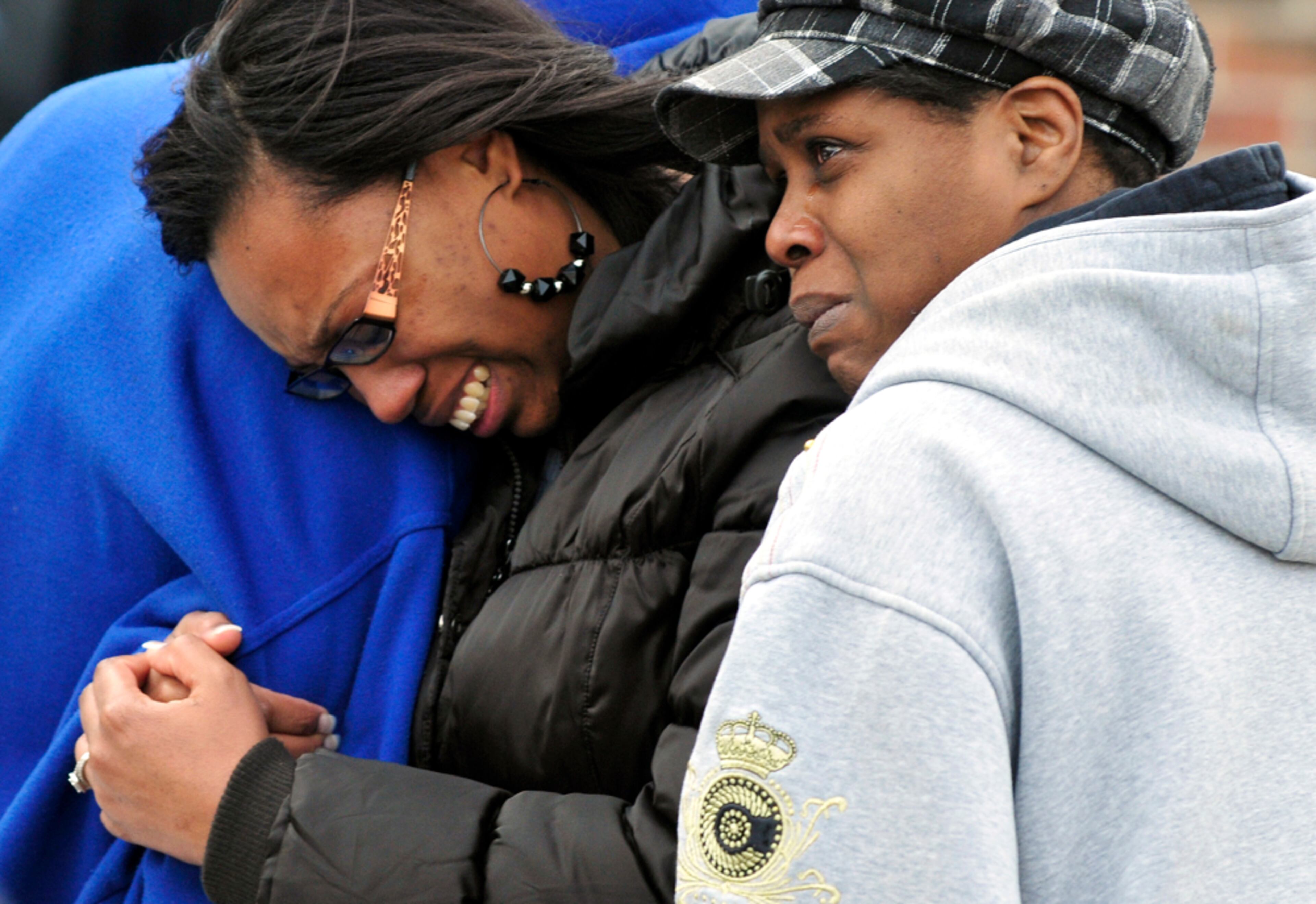 CHILDREN KILLED IN FIRE--Family members of children killed in an apartment fire grieve as Kalamazoo Public Safety officers respond to the fire, Monday, Feb. 18, 2013, in Kalamazoo, Mich. WWMT-TV and WOOD-TV are reporting that firefighters found the bodies of 3-year-old twins and a 1-year-old girl inside a unit at the Interfaith Apartments in Kalamazoo. (AP Photo/Kalamazoo Gazette-MLive Media Group, Matt Gade)