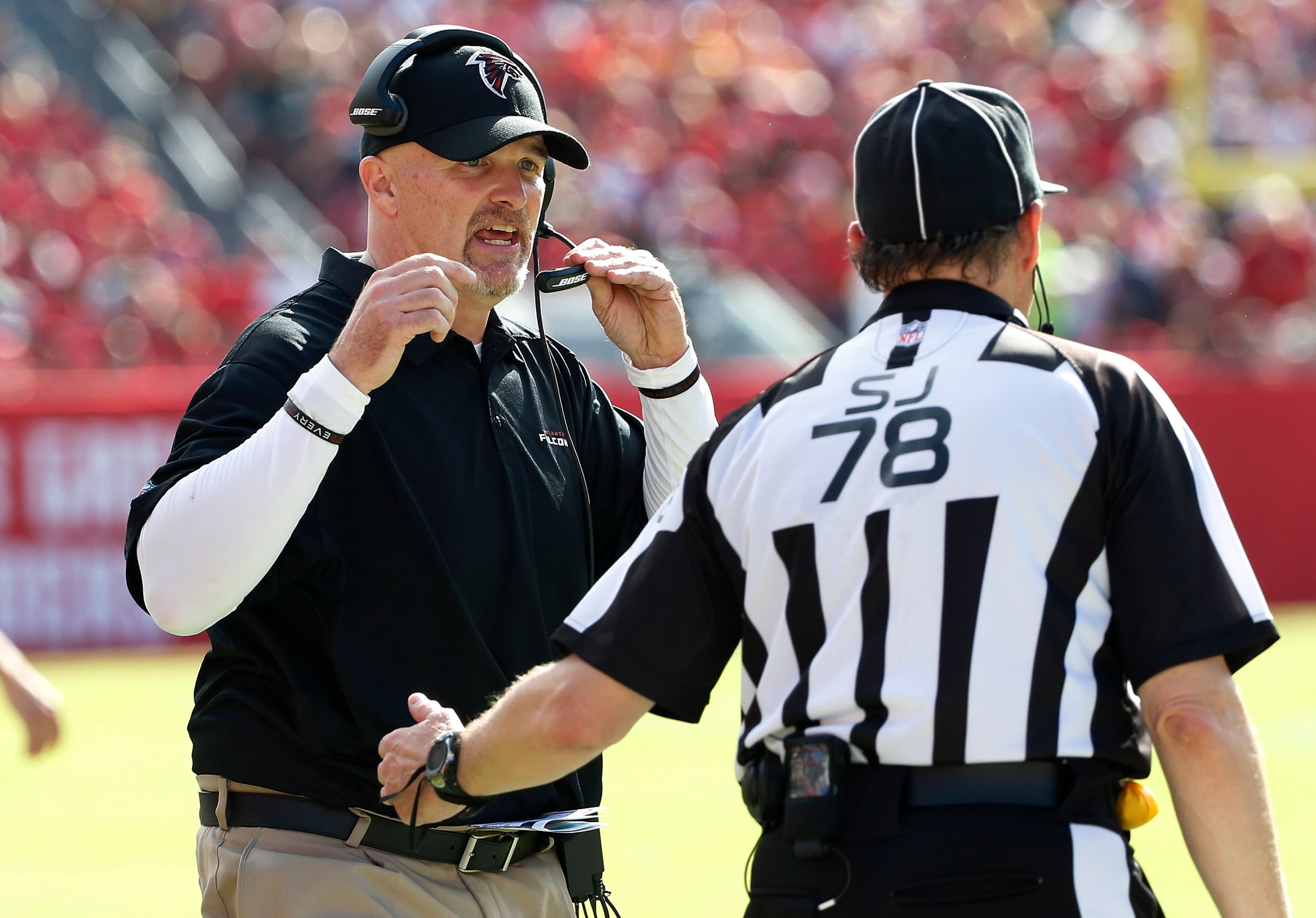 Atlanta Falcons head coach Dan Quinn talks to side judge Greg Meyer (78) during the fourth quarter of an NFL football game against the Tampa Bay Buccaneers Sunday, Dec. 6, 2015, in Tampa, Fla. (AP Photo/Brian Blanco)