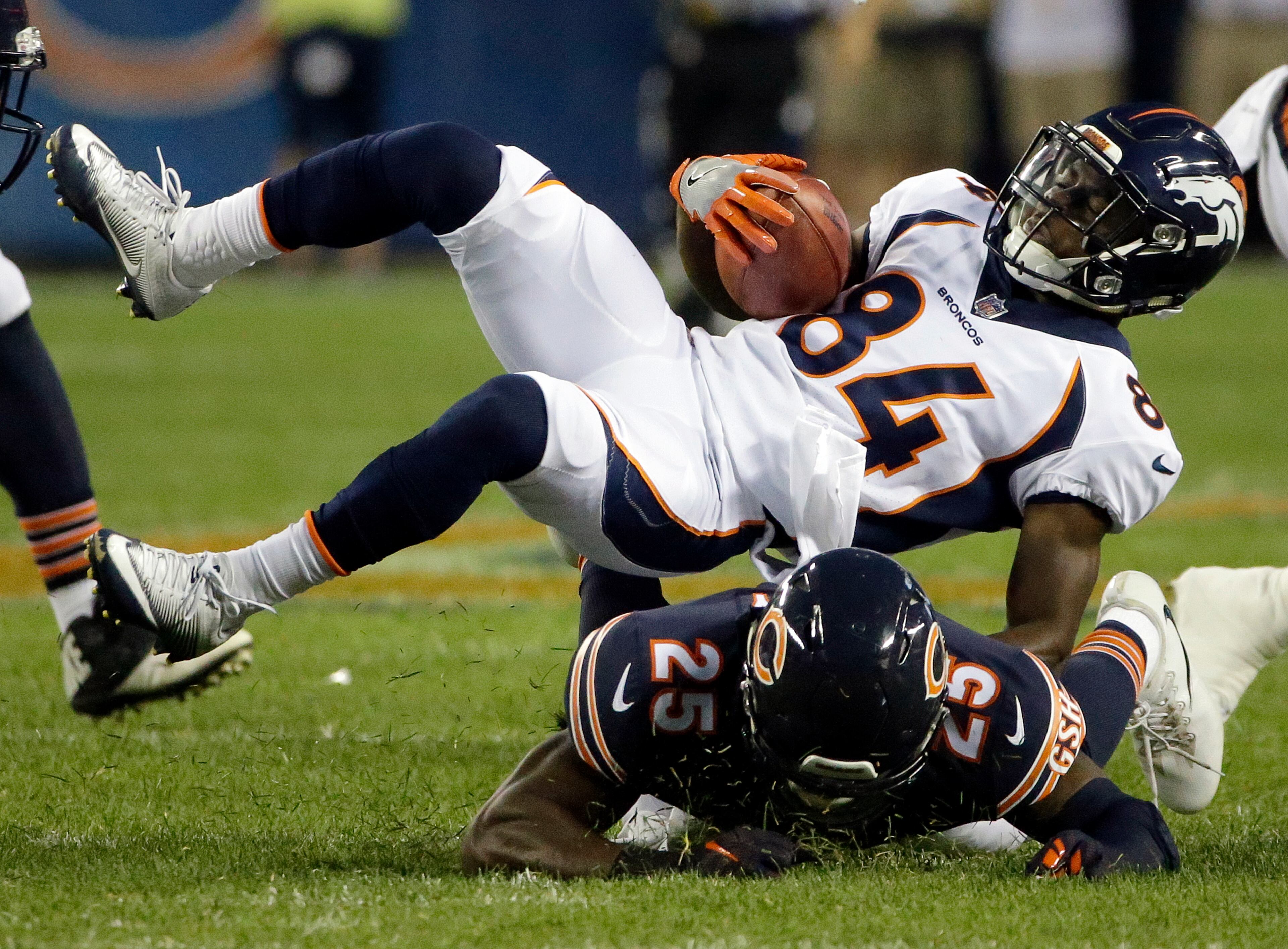 CORRECTS BEARS PLAYER TO MARCUS COOPER, INSTEAD OF KA'DEEM CAREY - Denver Broncos wide receiver Isaiah McKenzie (84) is tackled by Chicago Bears defensive back Marcus Cooper (25) during the first half of an NFL preseason football game, Thursday, Aug. 10, 2017, in Chicago. (AP Photo/Nam Y. Huh)