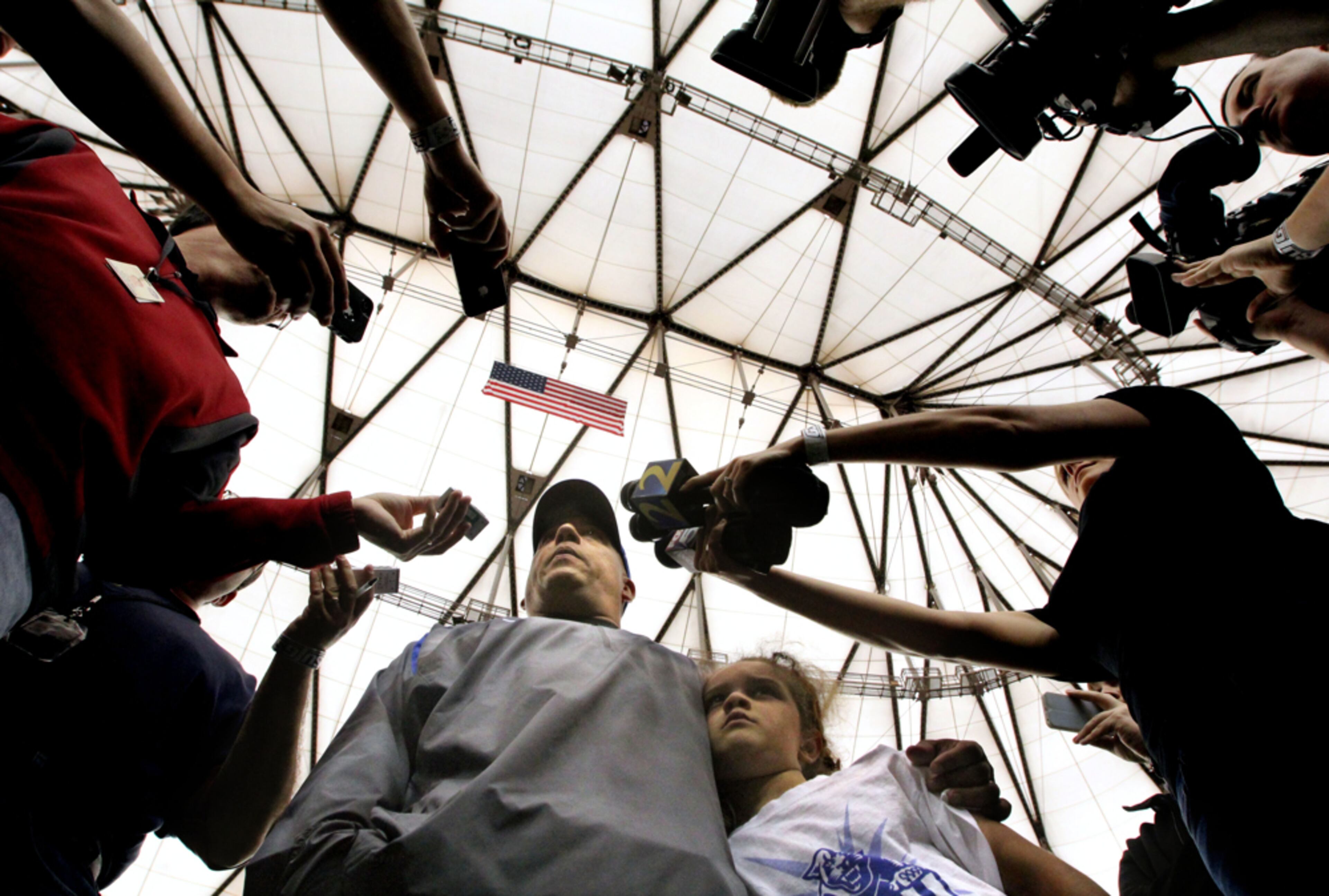 April 20, 2013 - Atlanta, Ga: Georgia State University first year football coach Trent Miles stands with his daughter Kaylee, 7, as he talks with members of the media following the GSU blue-white spring scrimmage in the Georgia Dome Saturday afternoon in Atlanta, Ga., April 20, 2013. Getz said, "I like this image because of the unique angle and how the ceiling of the Georgia Dome becomes a recognizable element to the photograph." JASON GETZ / JGETZ@AJC.COM