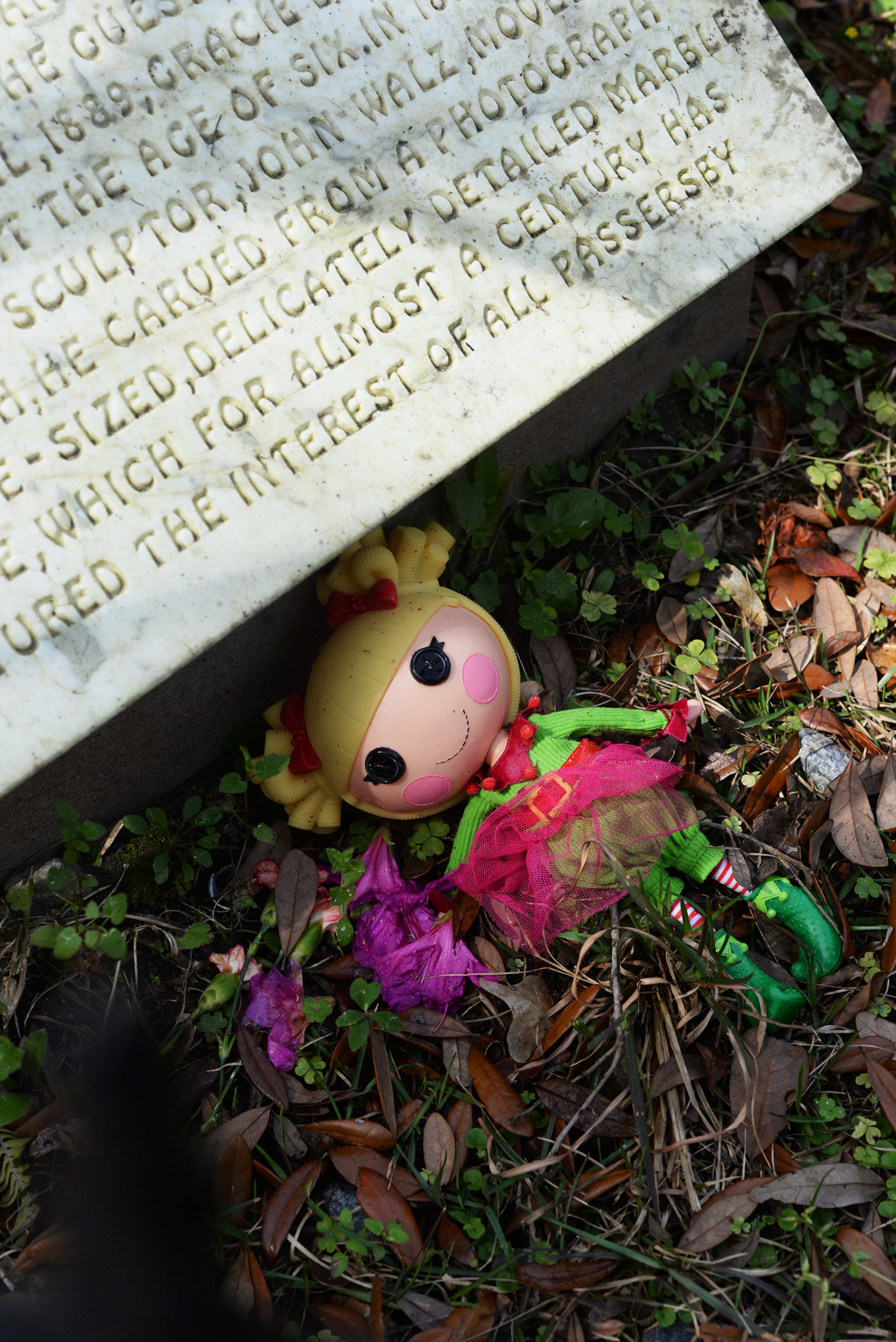 Travelers visit the grave of "Little Gracie," one of the world's most-visited graves, in Bonaventure Cementery in Savannah, Ga. on Friday, March 18, 2016. Gracie Watkins died in Savannah in 1889 after suffering from pneumonia.