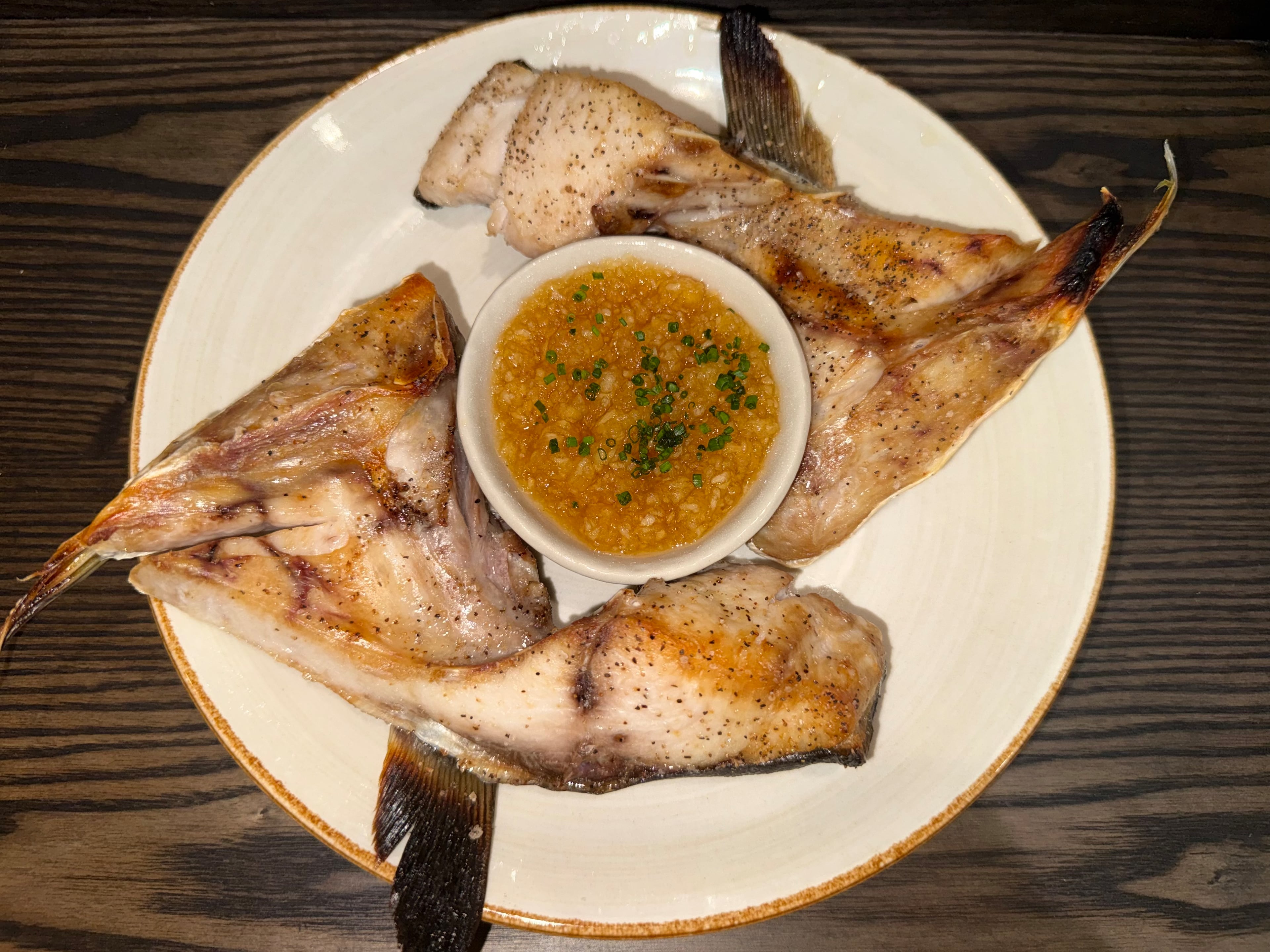 Grilled hamachi kama gets a seasonal twist with apple ponzu at NoriFish Sushi & Izakaya. (Courtesy of NoriFish Sushi & Izakaya)