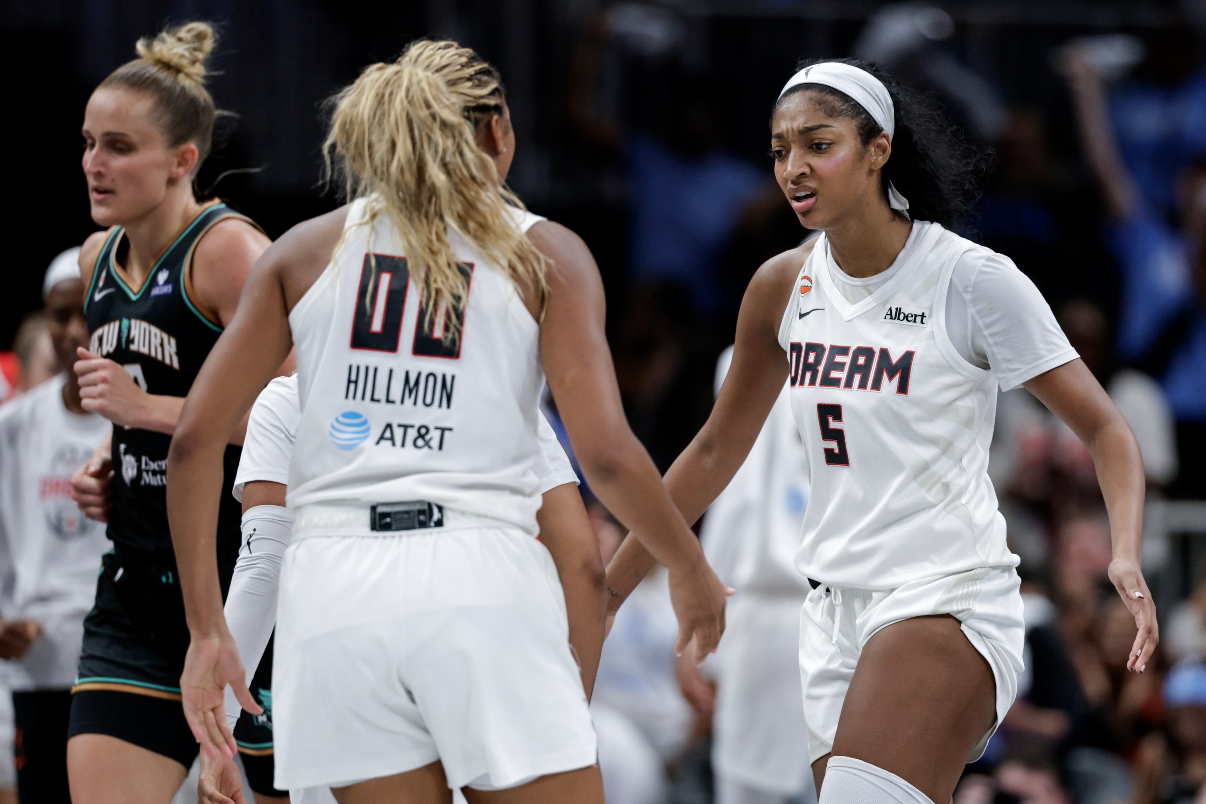 Atlanta Dream forward Angel Reese (5) reacts with forward Naz Hillmon (00) during the second half of a WNBA semifinal playoff game 1 between the Atlanta Dream and the New York Liberty, Sunday, Oct. 4, 2026, in Atlanta. (Erik S. Lesser for the AJC)