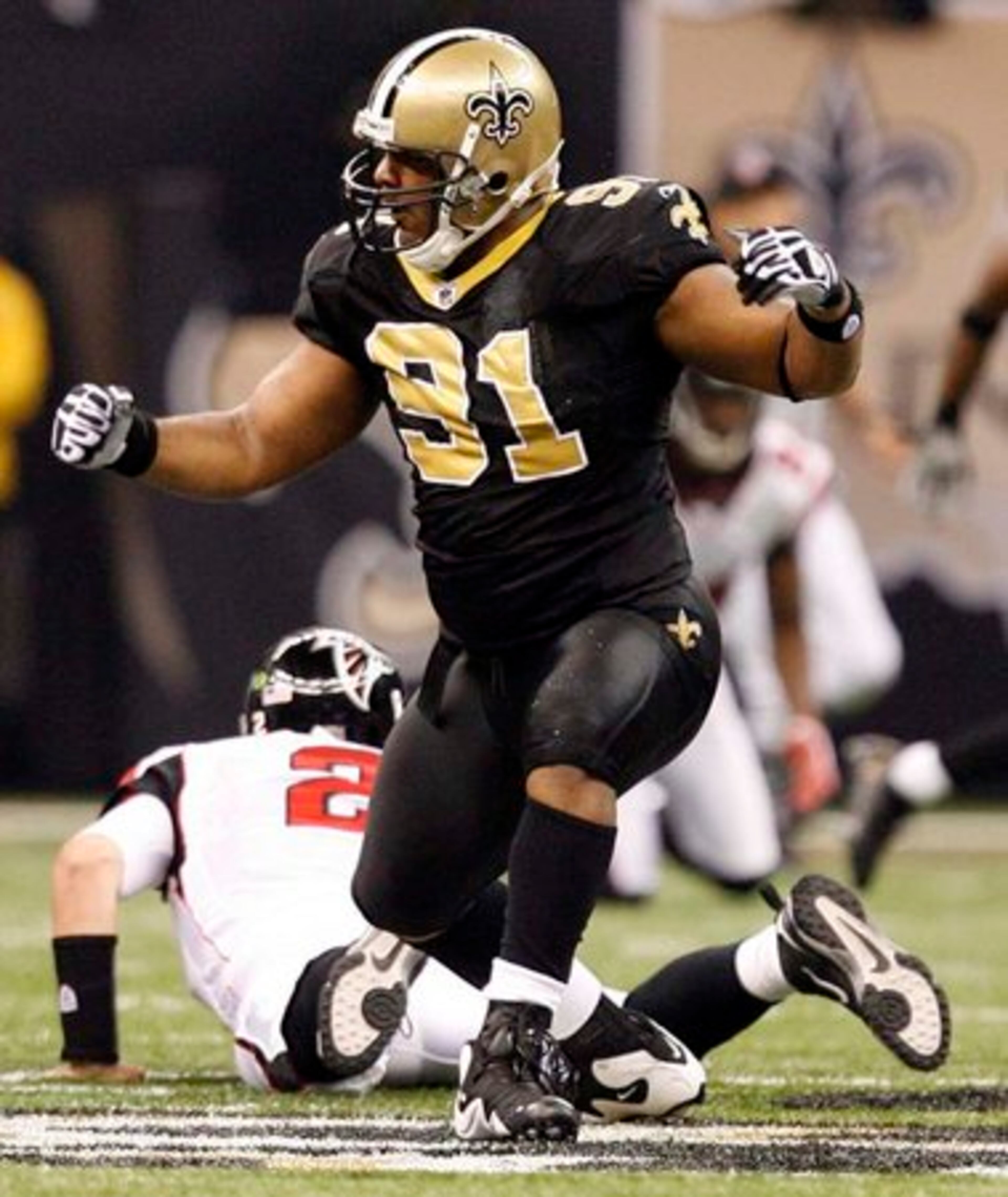 Saints defensive end Will Smith celebrates after sacking Falcon quarterback Matt Ryan.