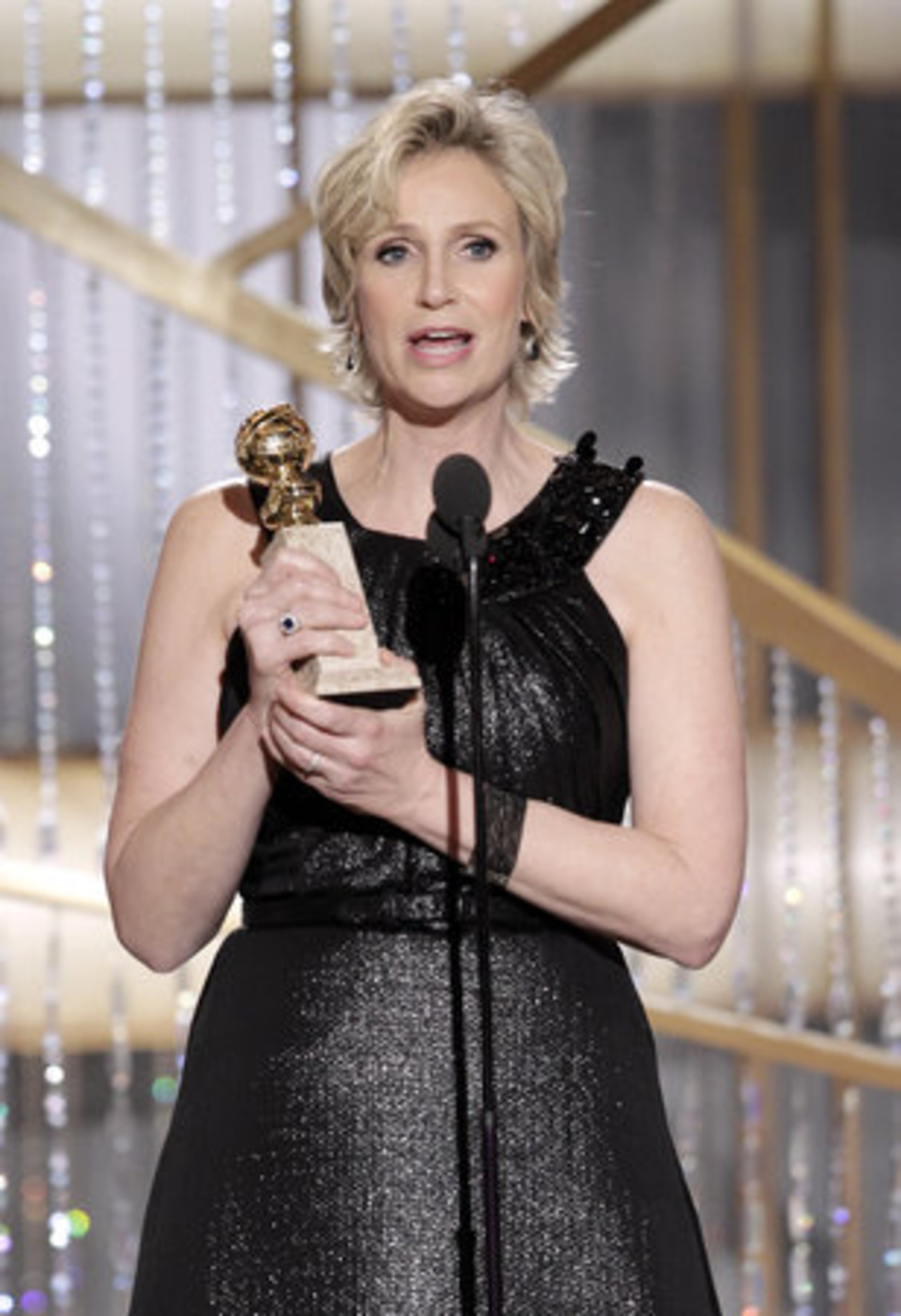In this publicity image released by NBC, actress Jane Lynch holds the award for Best Supporting Actress in a Series/Mini-Series/TV Movie for her role in "Glee, " during the Golden Globe Awards, Sunday, Jan. 16, 2011 in Beverly Hills, Calif.