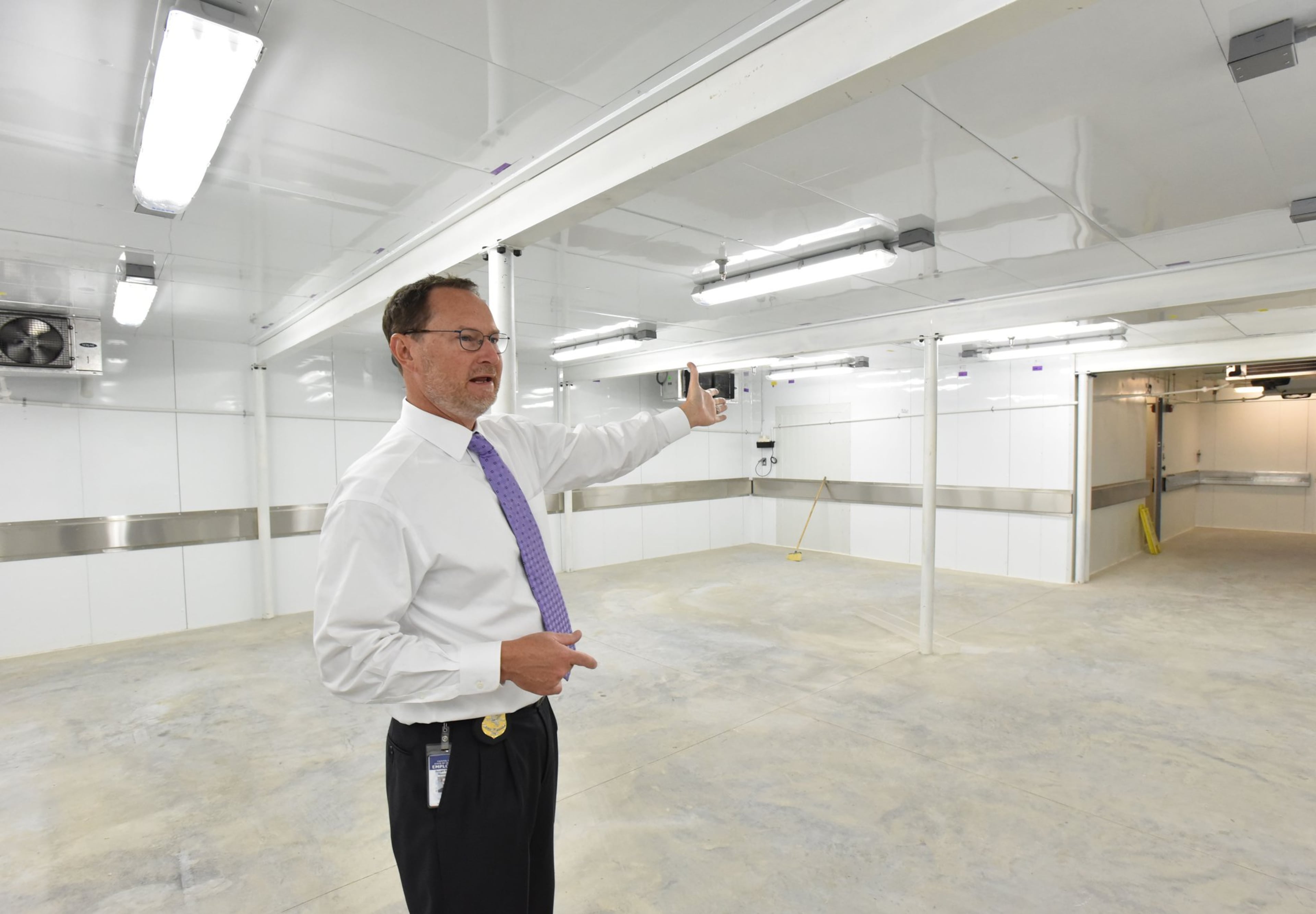 J. Bahan Rich, deputy director of the GBI public affairs office, shows the new morgue cooler in the GBI Medical Examiner Annex on September 6, 2017.