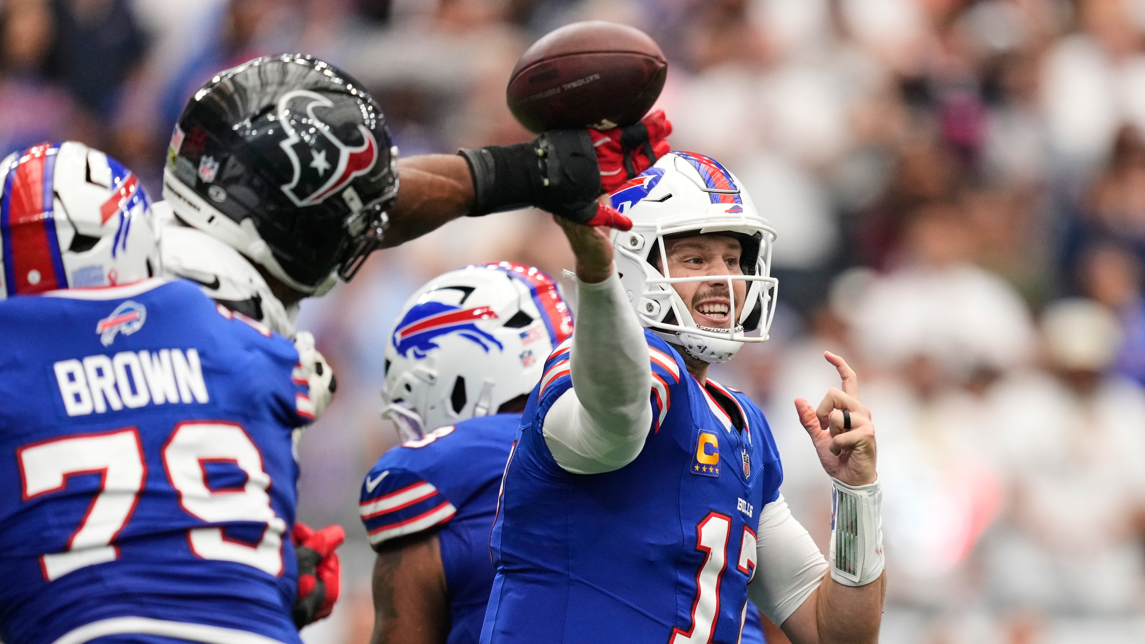 Buffalo Bills quarterback Josh Allen (17) throws an incomplete pass forced by Houston Texans defensive end Danielle Hunter, second from left, during the second half of an NFL football game, Sunday, Sept. 13, 2026, in Houston. (AP Photo/Ashley Landis)