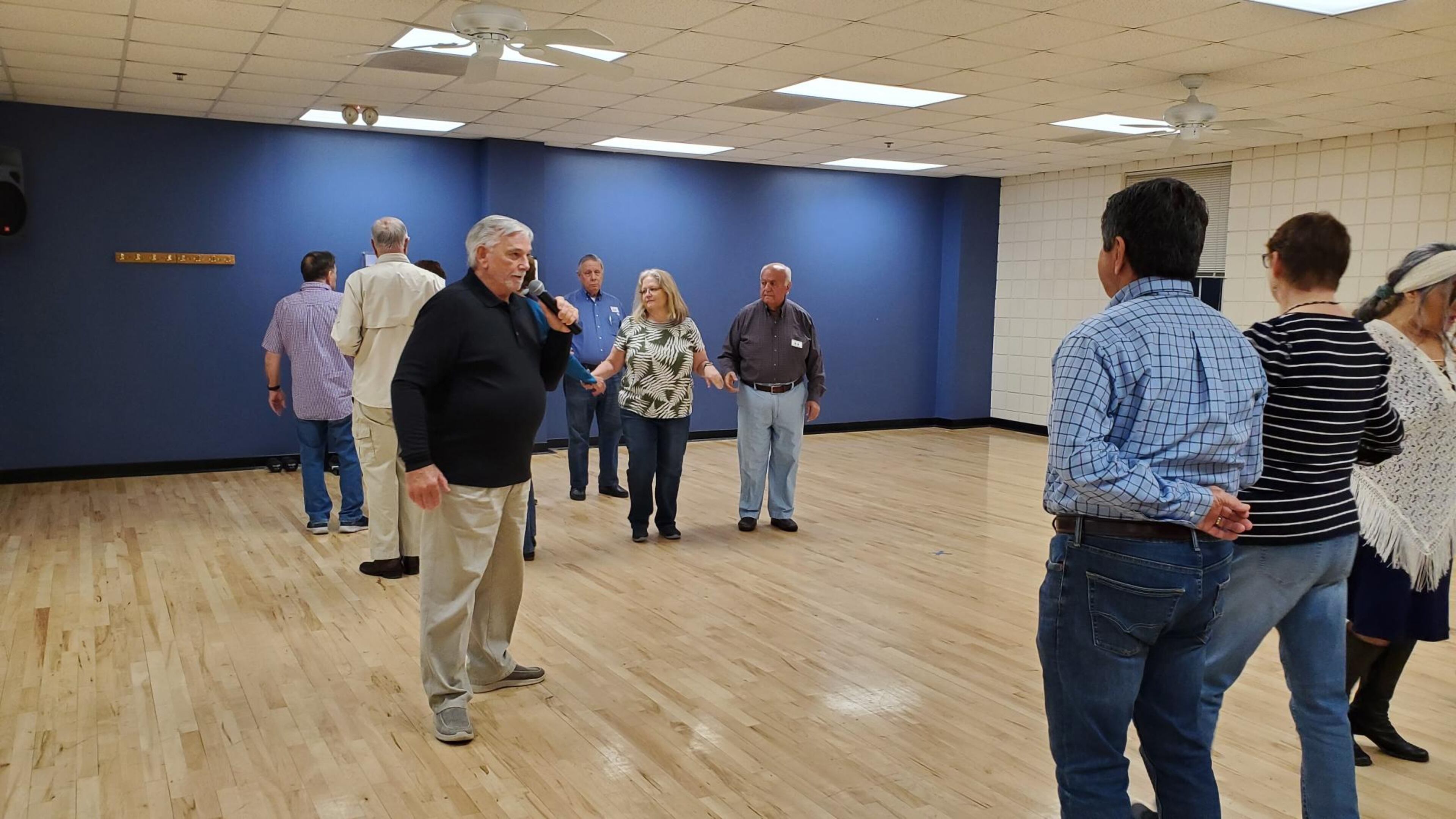 Dan Mitchell, the Peachtree Squares caller, calls a dance.