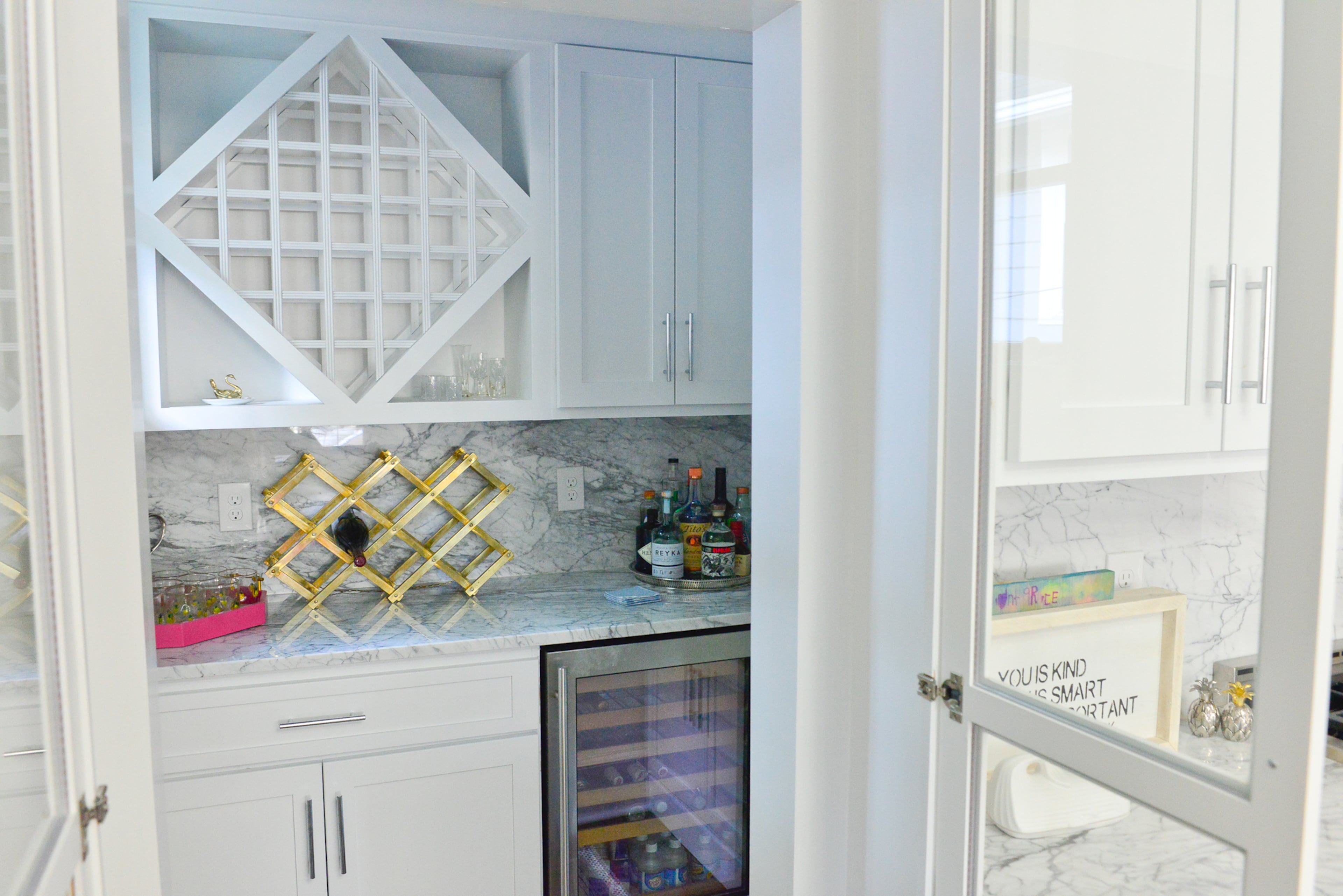 The home is equipped with a butler's pantry, complete with refrigeration and a geometric wine rack.