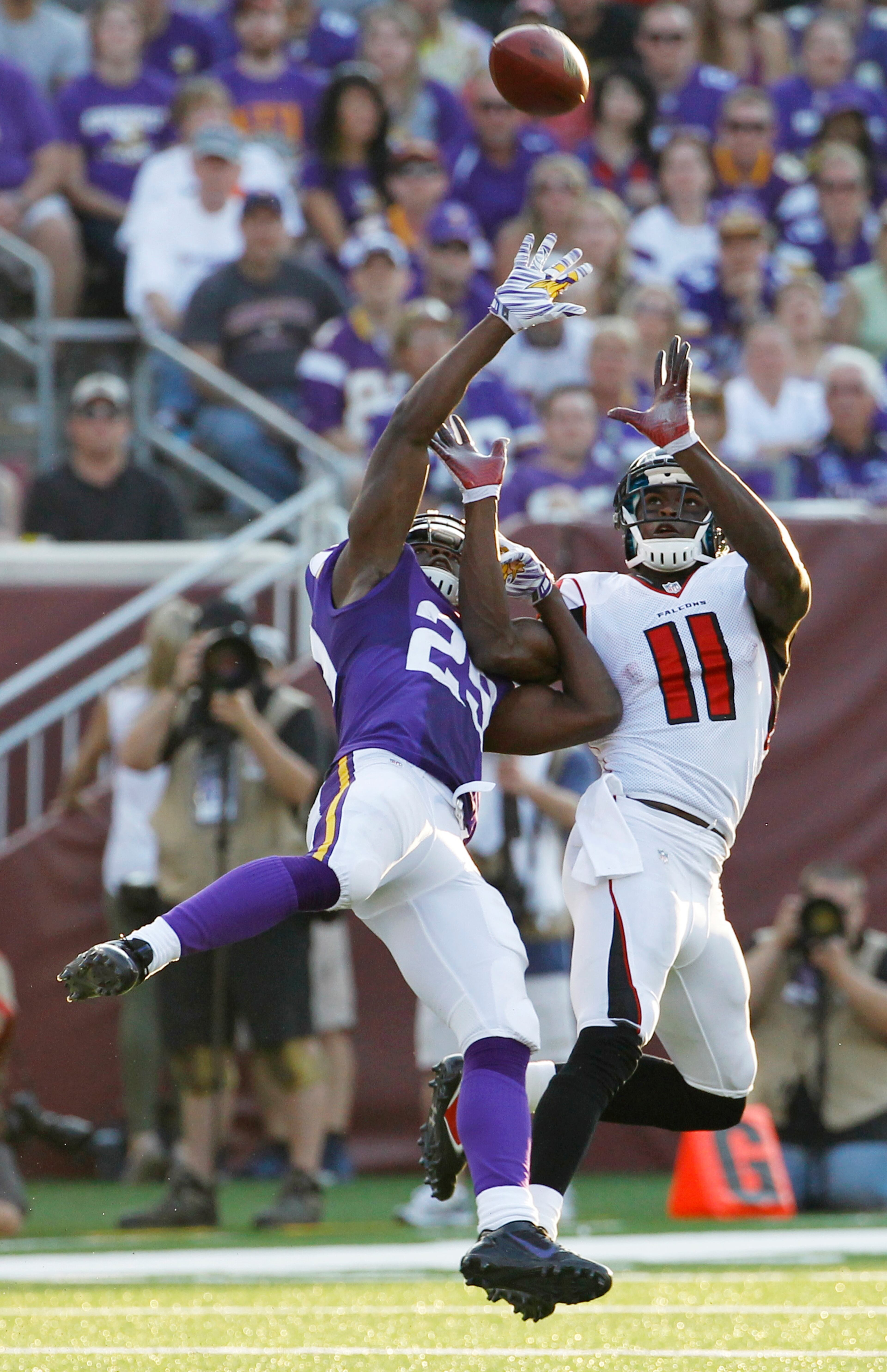 Minnesota Vikings cornerback Xavier Rhodes, left, breaks up a pass intended for Atlanta Falcons wide receiver Julio Jones (11) during the second half of an NFL football game, Sunday, Sept. 28, 2014, in Minneapolis. (AP Photo/Ann Heisenfelt)