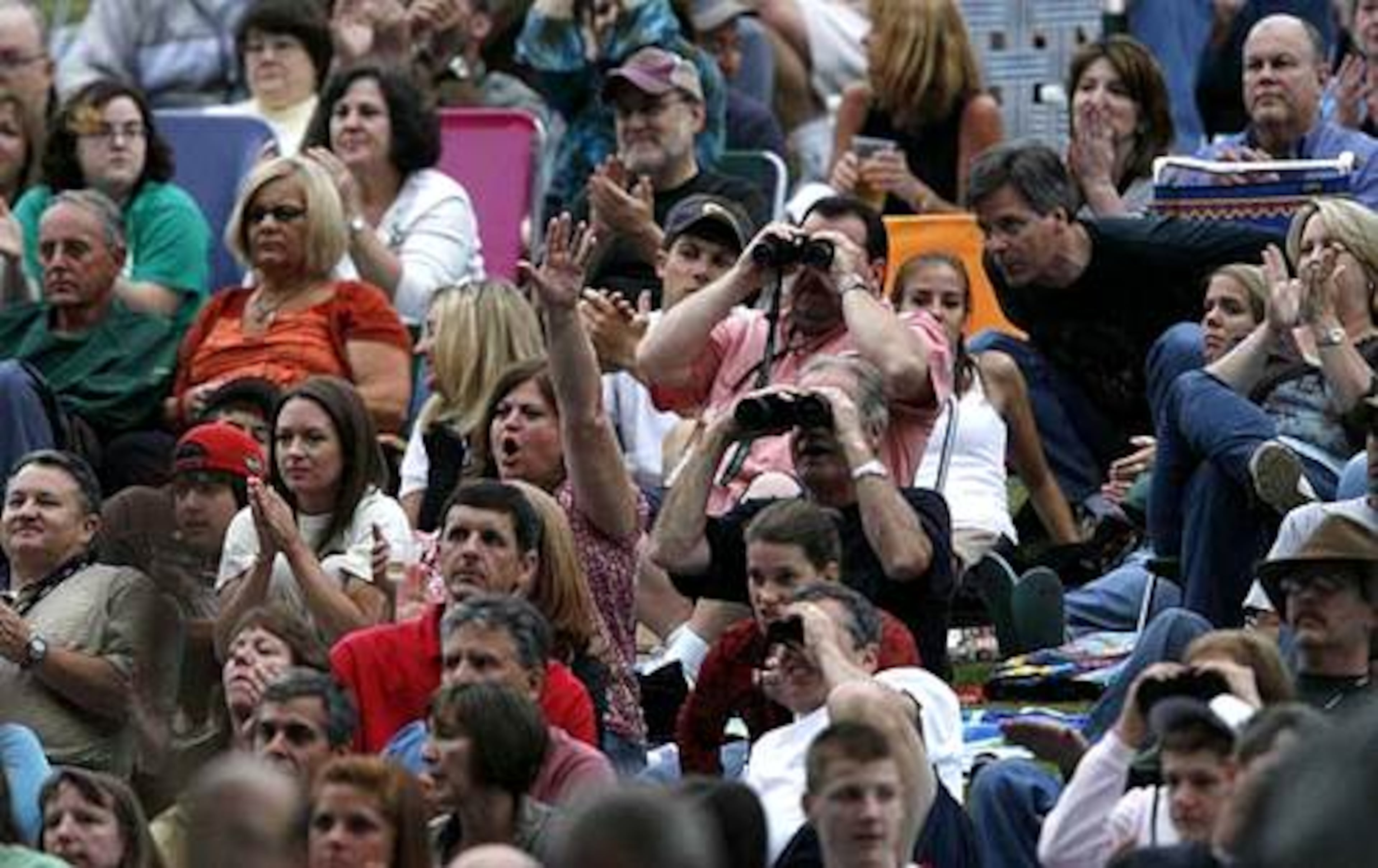 Fans on the lawn cheer the opening number of the Eagles. They are the first major rock band to play at the park. All four shows are sold out.