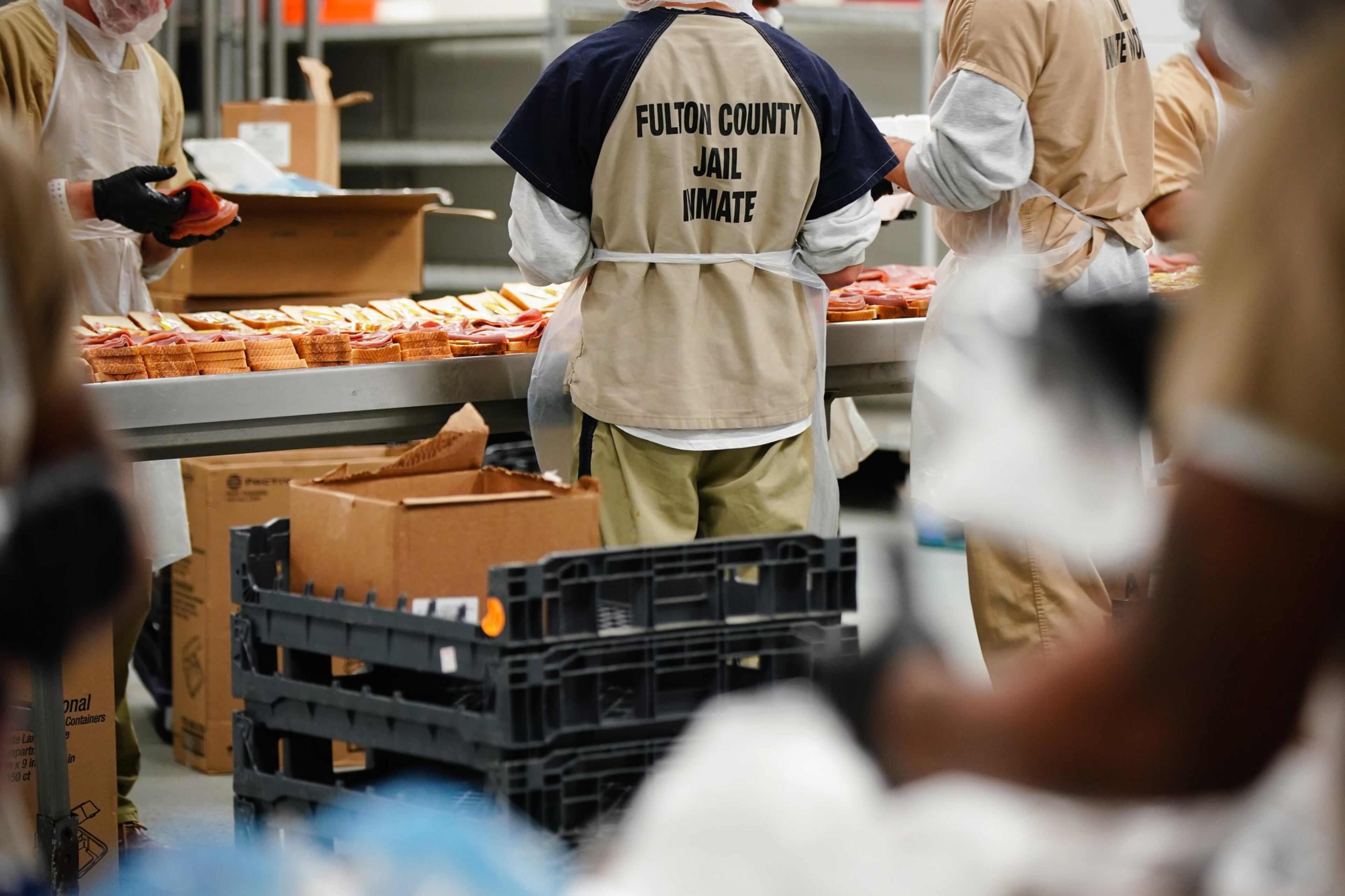 Inmates are seen preparing sandwiches for lunch in the kitchen during a tour of the Fulton County Jail on Monday, December 9, 2019, in Atlanta. (Elijah Nouvelage/Special to the Atlanta Journal-Constitution)