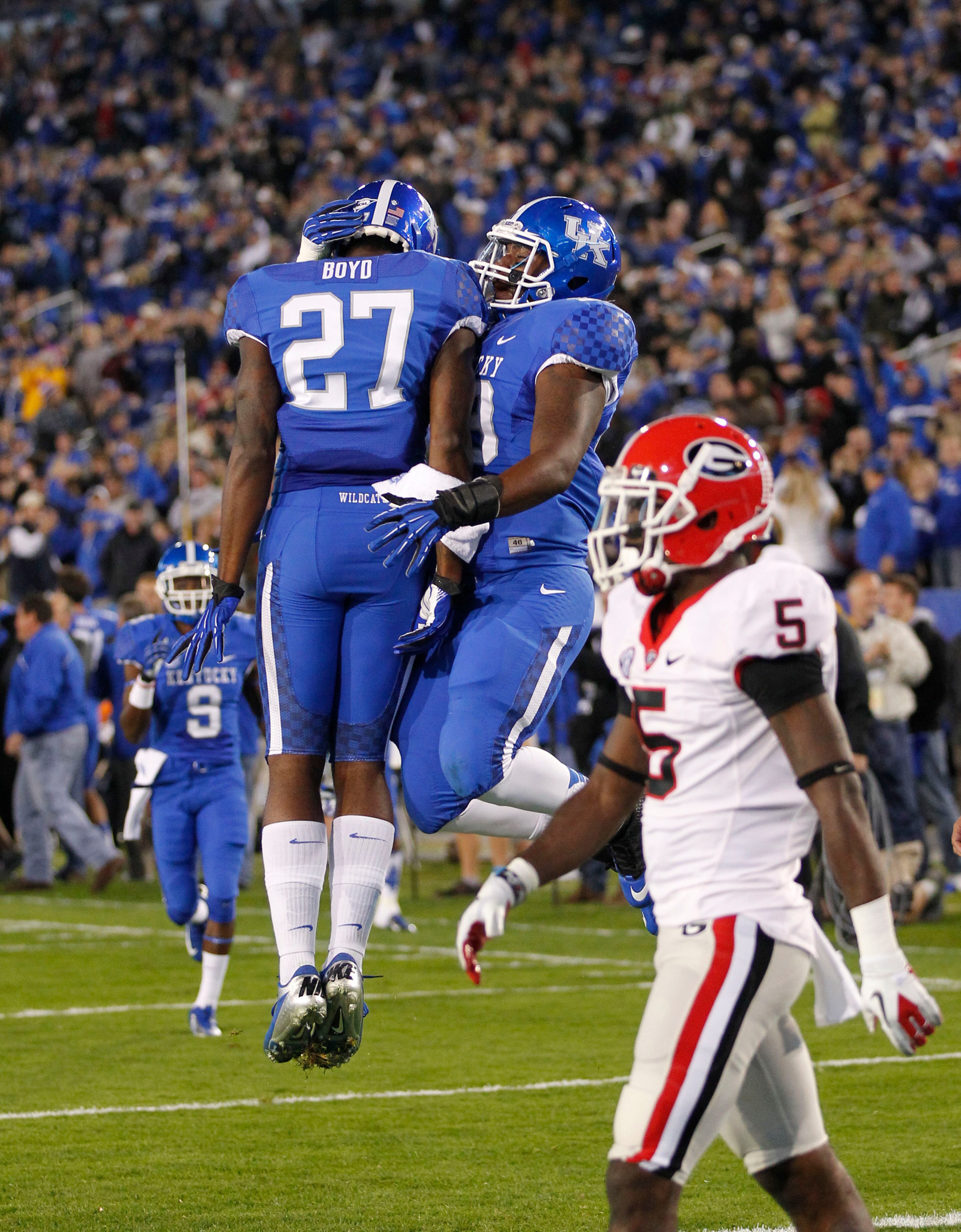 Kentucky Wildcats wide receiver Aaron Boyd (27) celebrated with Kentucky Wildcats wide receiver Demarco Robinson (9).