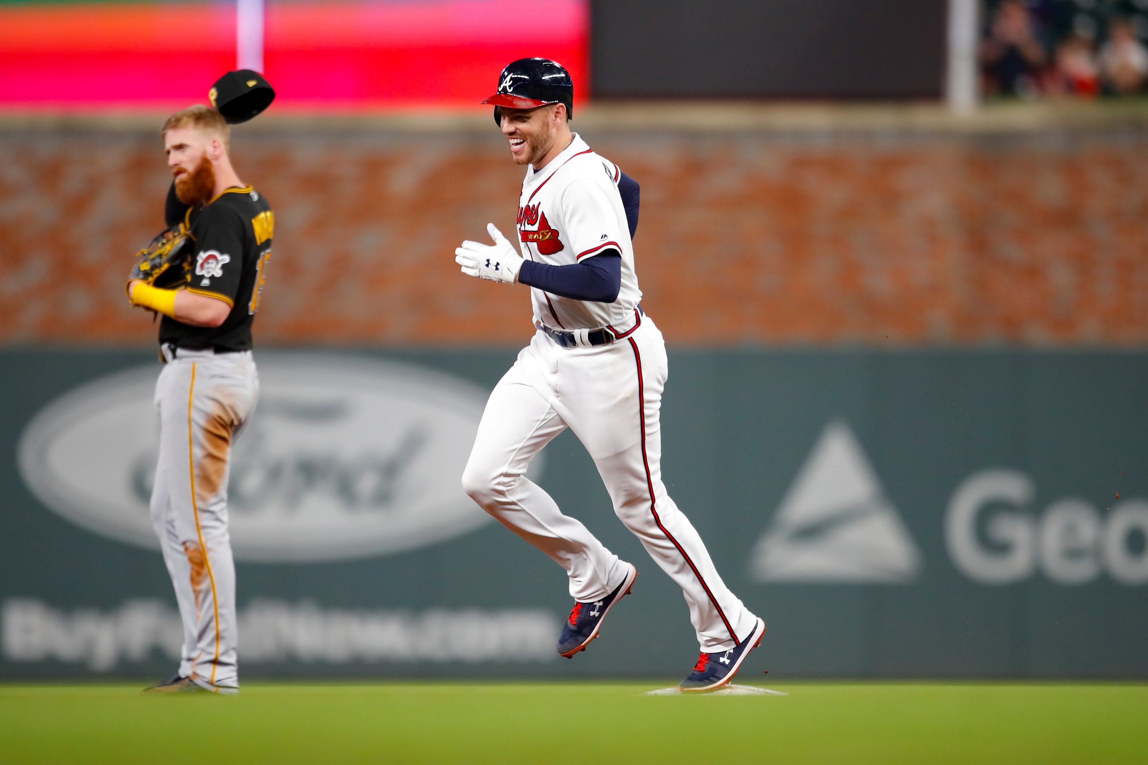 Freddie Freeman smiles as he trots around the bases after his fourth-inning home run. (Photo by Todd Kirkland/Getty Images)