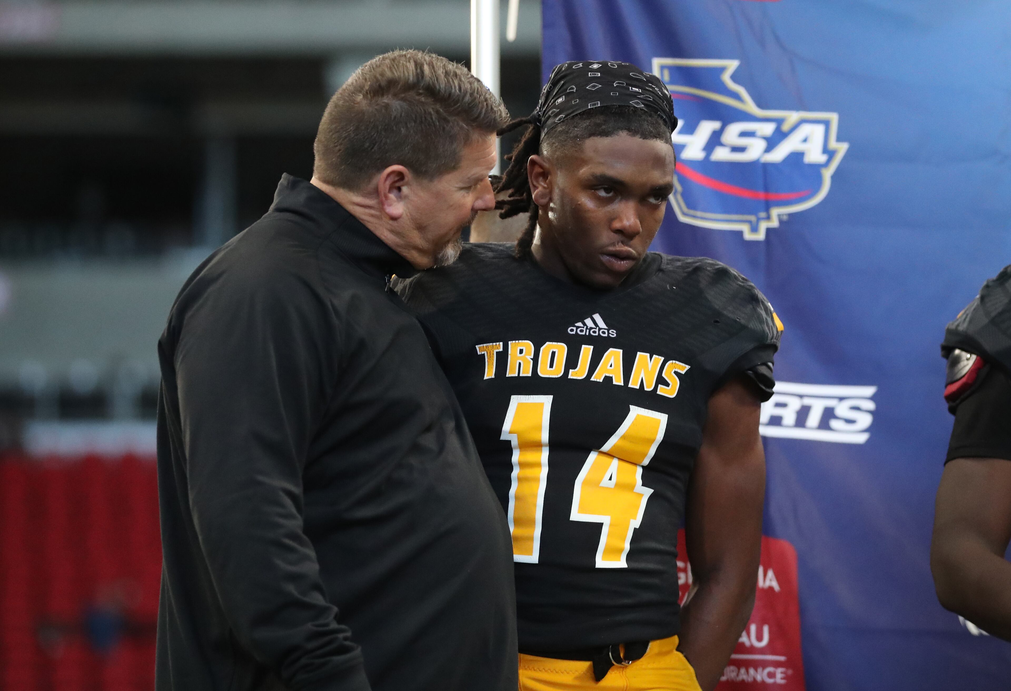 Peach County coach Chad Campbell consoles wide receiver Terkel Jefferson (14) after their loss to Cedar Grove in the Class AAA State Championship at Mercedes-Benz Stadium Tuesday, December 11, 2018, in Atlanta. Cedar Grove won 14-13. (Jason Getz/Special to the AJC)