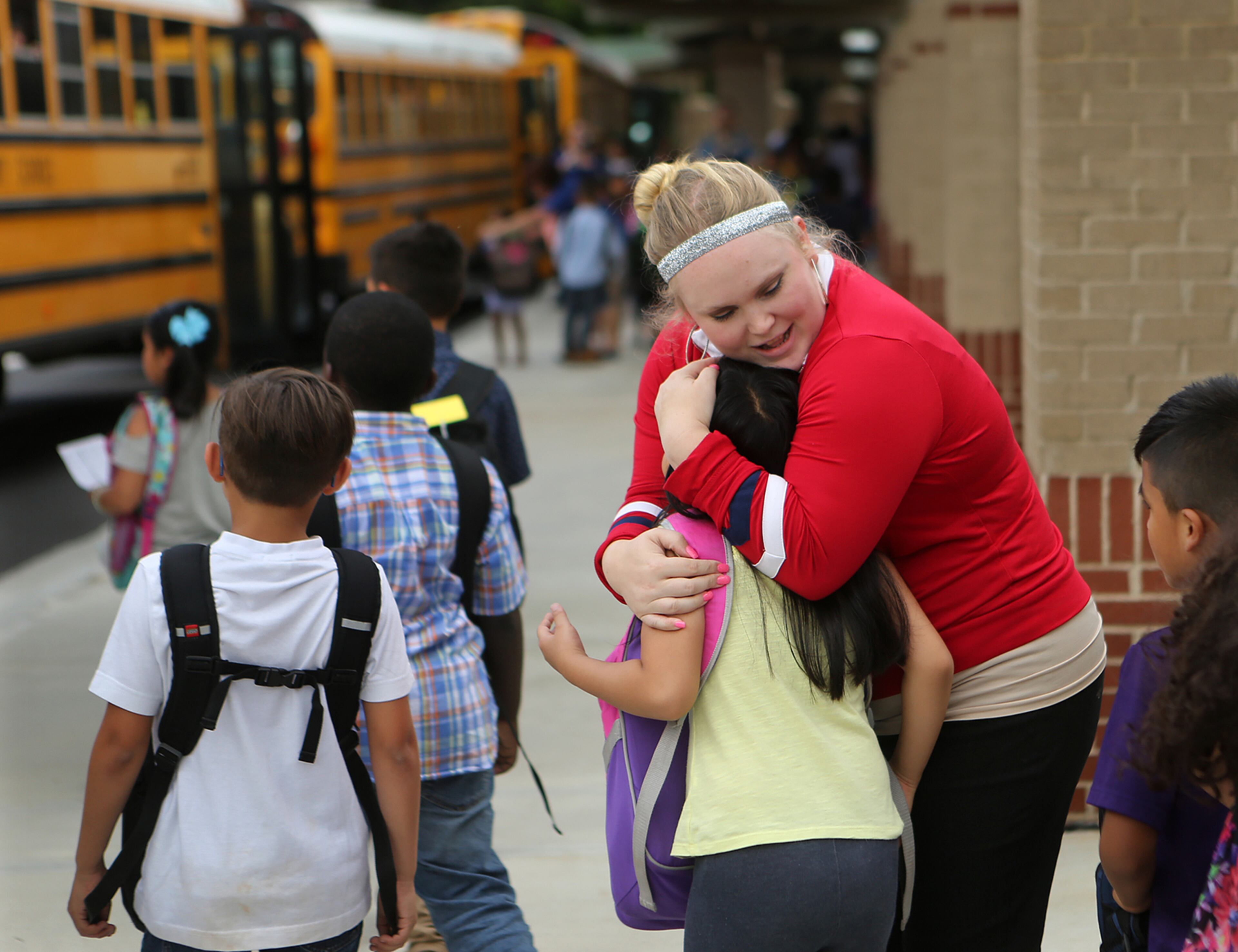 May 24, 2017, Norcross: First year teacher Audrey Smith hugs Carolyn Do goodbye while walking her students to the buses on the last day of school at Baldwin Elementary School on Wednesday, May 24, 2017, in Norcross. Curtis Compton/ccompton@ajc.com