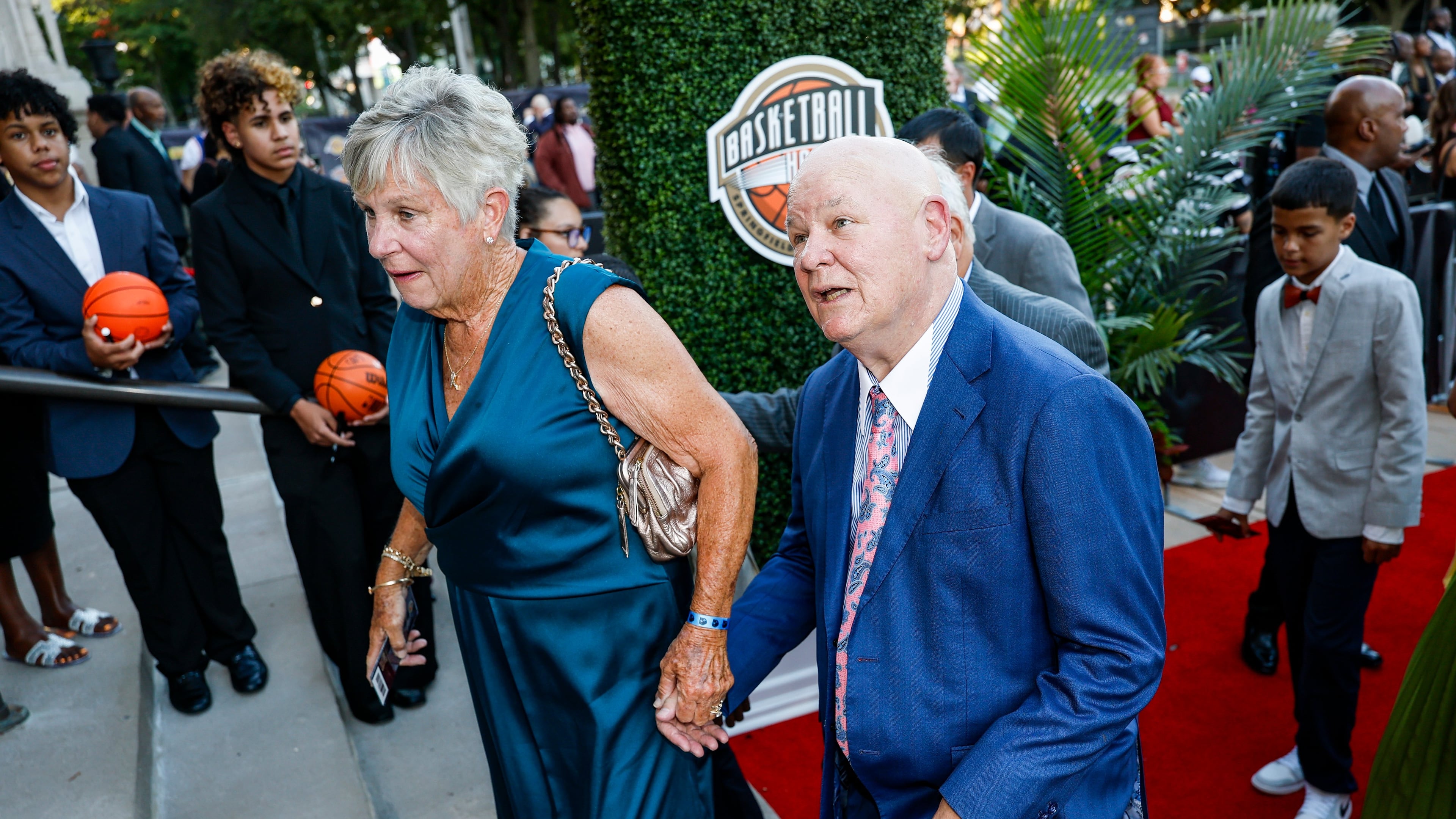 Veteran NBA referee and 2026 inductee Joey Crawford, right, recognizes his image on the columns of Symphony Hall as he enters the 2026 Naismith Basketball Hall of Fame induction ceremony Saturday, Aug. 15, 2026, in Springfield, Mass. (AP Photo/Rusty Jones)