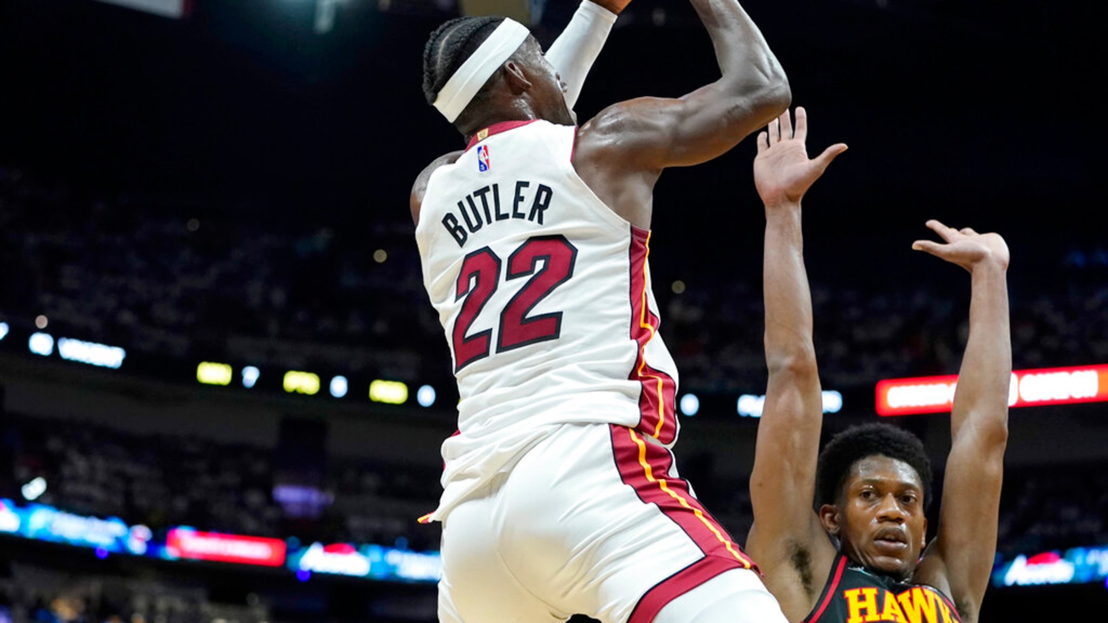 Heat forward Jimmy Butler shoots as Hawks forward De'Andre Hunter defends during the first half of Game 2 of a first-round NBA playoff series Tuesday night in Miami. (AP Photo/Lynne Sladky)